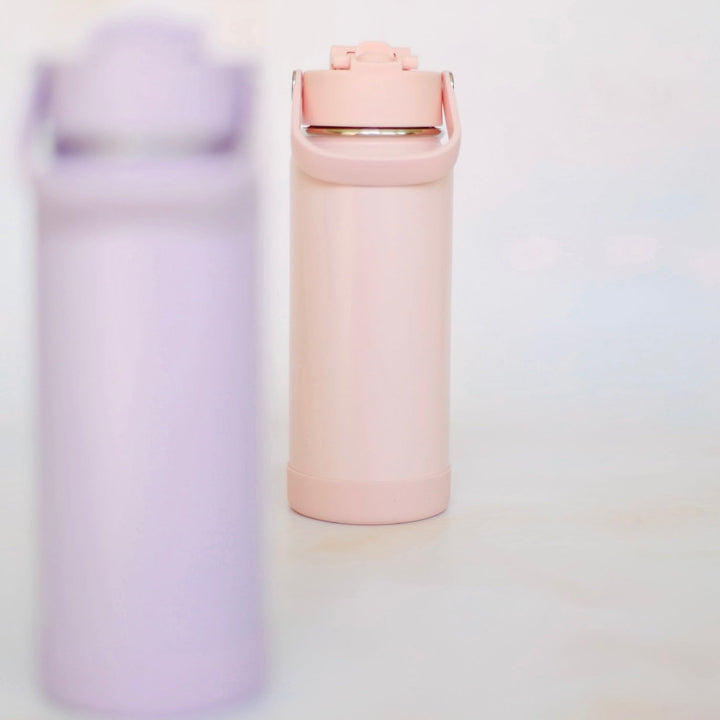 Two pastel-colored water bottles on a light background