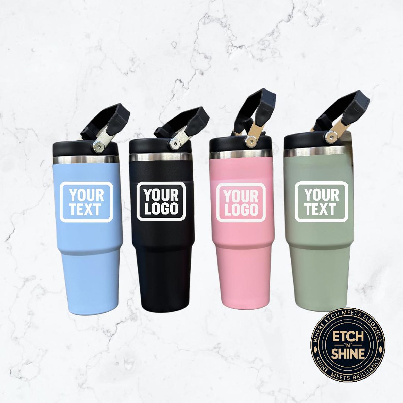 Four insulated travel mugs in different colors with customizable text or logo areas on a marble background.