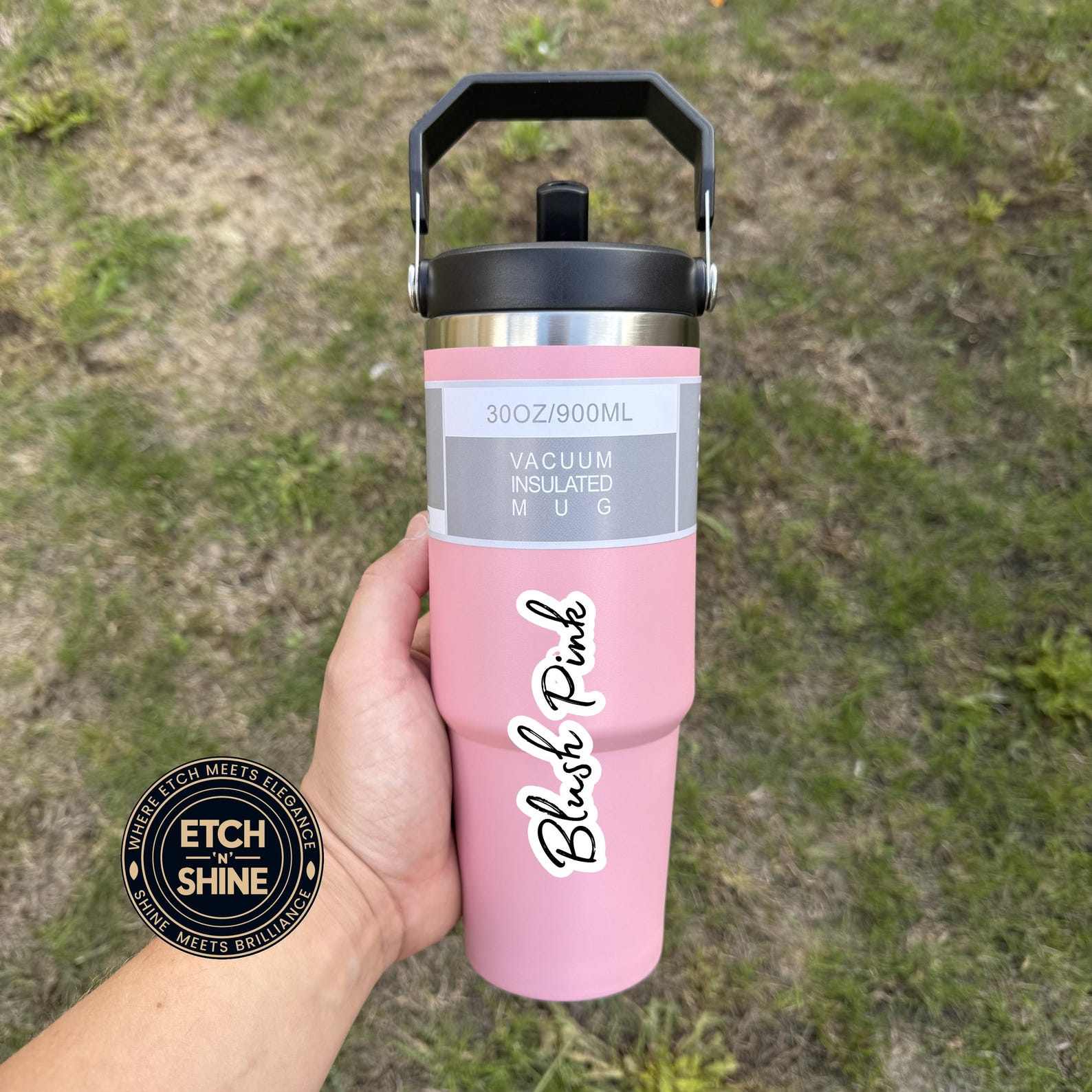 Pink insulated mug with 'Blush Pink' text held by a hand against a grassy background, featuring 'Etch n Shine' branding.