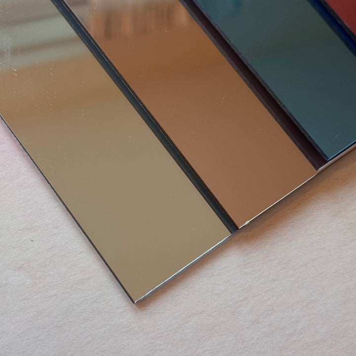 Close-up of mirror acrylic surface showing reflective finish in gold and rose gold – laser engraving material – Etch 'N' Shine