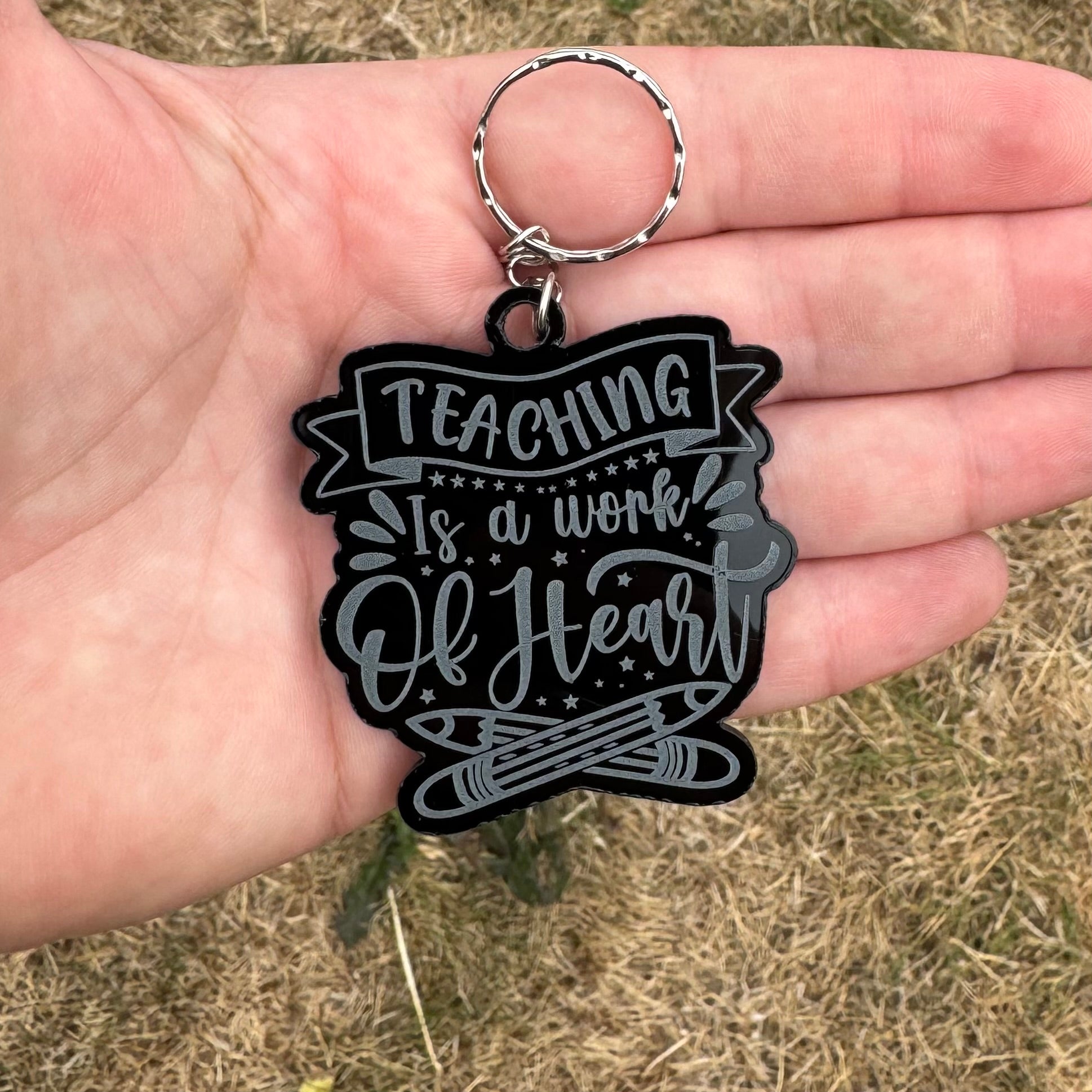 Heartfelt black acrylic keychain for teachers with the quote ‘Teaching is a work of heart’ – personalised appreciation gift
