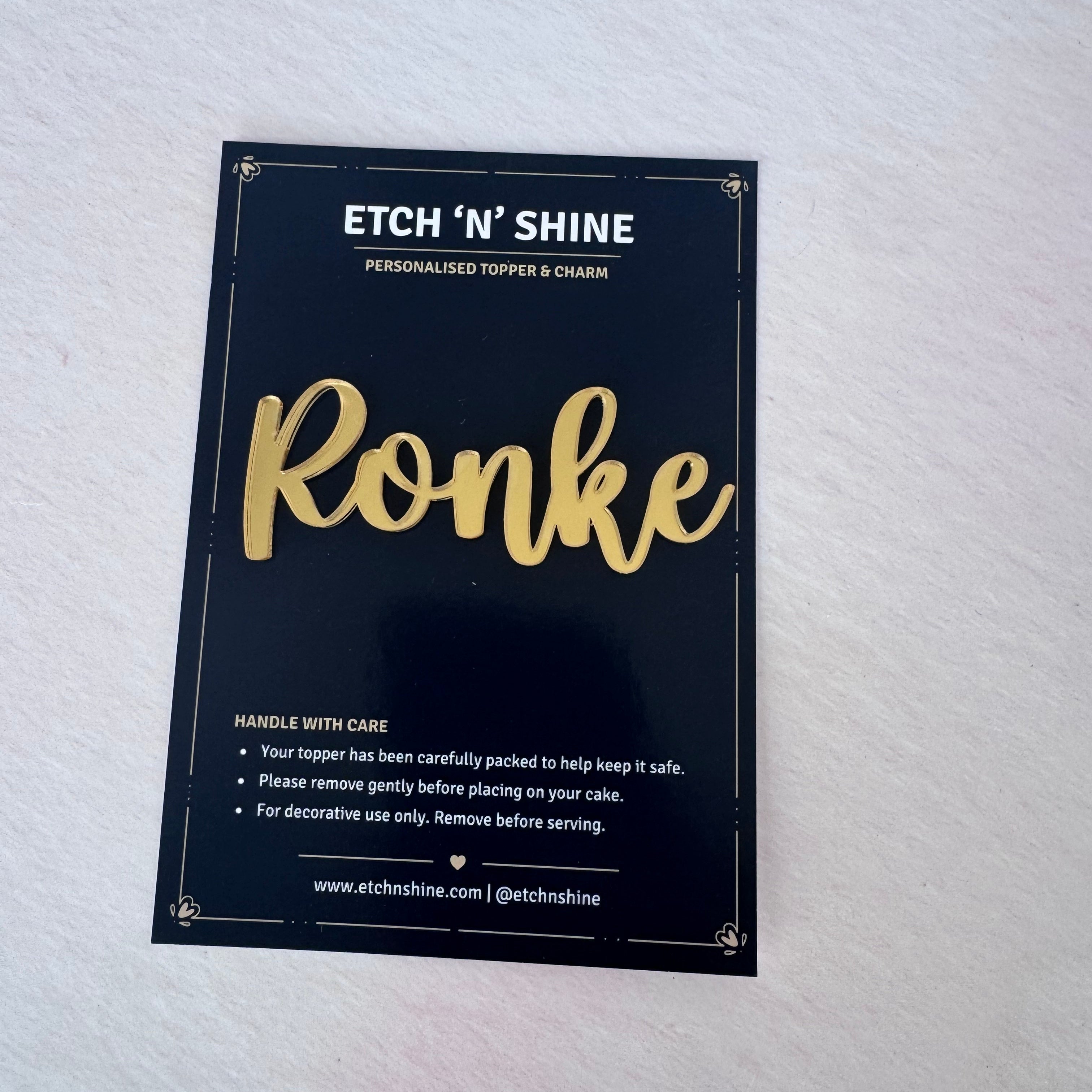 Gold mirror acrylic personalised name cake topper in presentation packaging