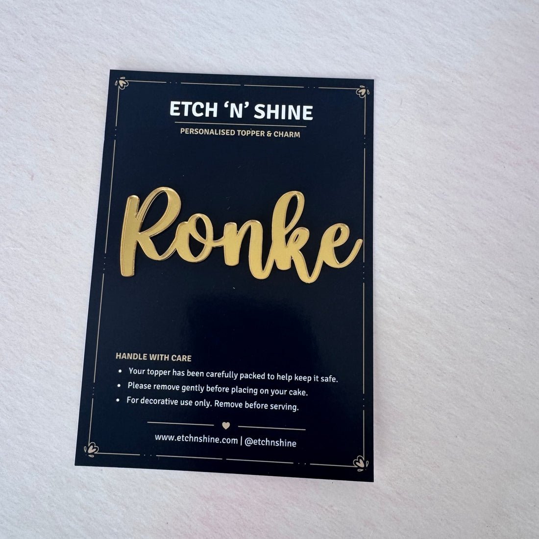 Gold mirror acrylic personalised name cake topper in presentation packaging