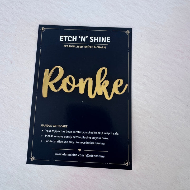 Gold mirror acrylic personalised name cake topper in presentation packaging