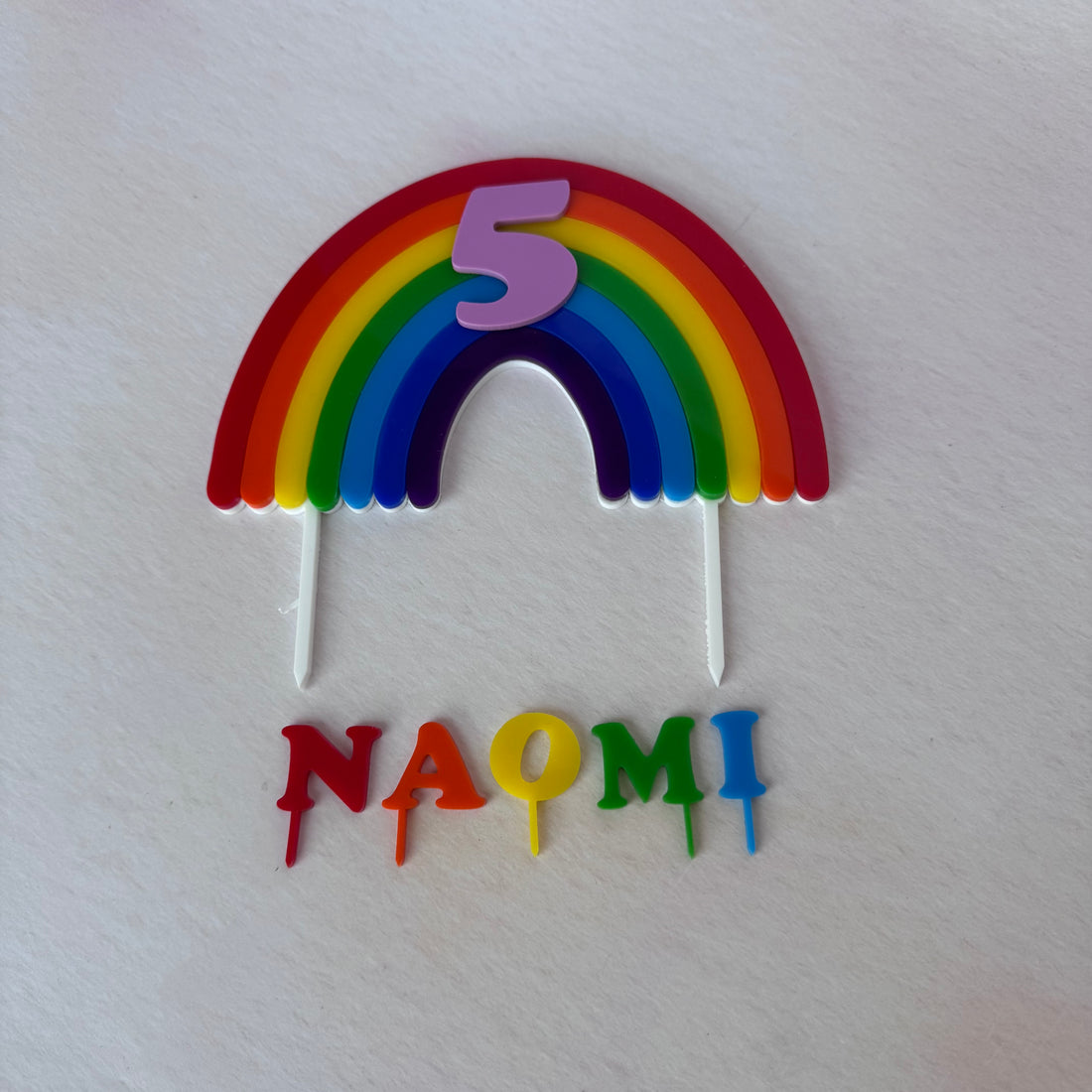 Rainbow arch number 5 topper with NAOMI letters on stakes, flat lay – personalised rainbow cake topper set – Etch 'N' Shine