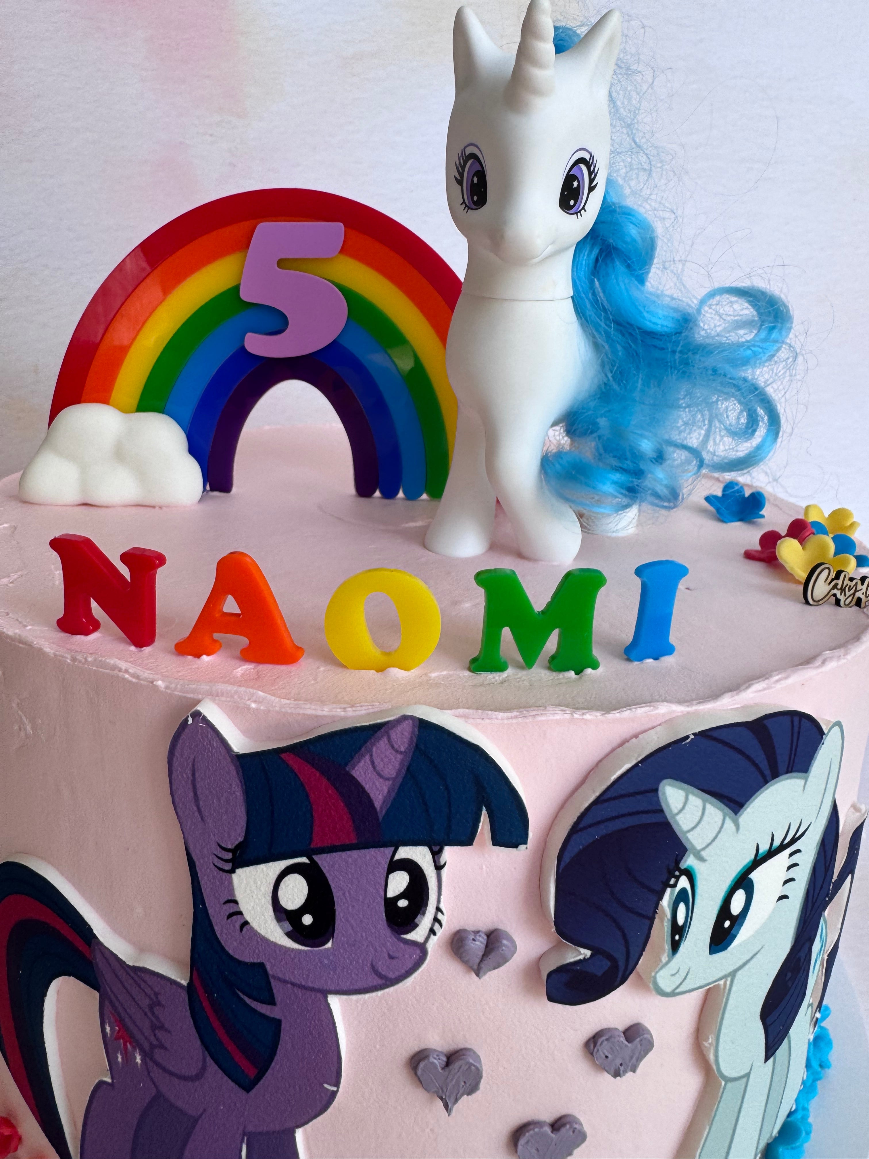 Rainbow arch and NAOMI name set in place on a birthday cake – bespoke acrylic topper set – Etch 'N' Shine