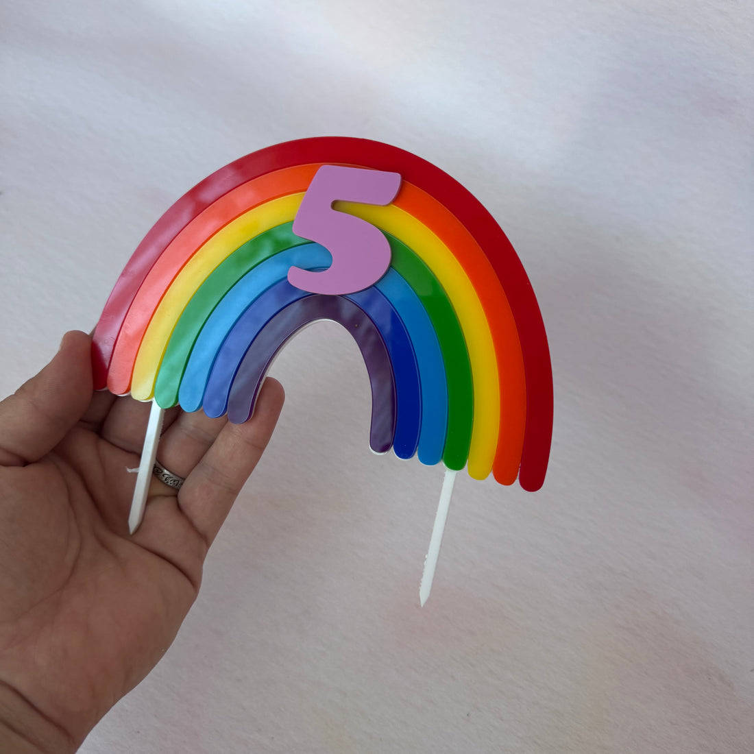 Close-up of a rainbow acrylic number 5 topper with cloud shapes – personalised rainbow cake topper – Etch 'N' Shine