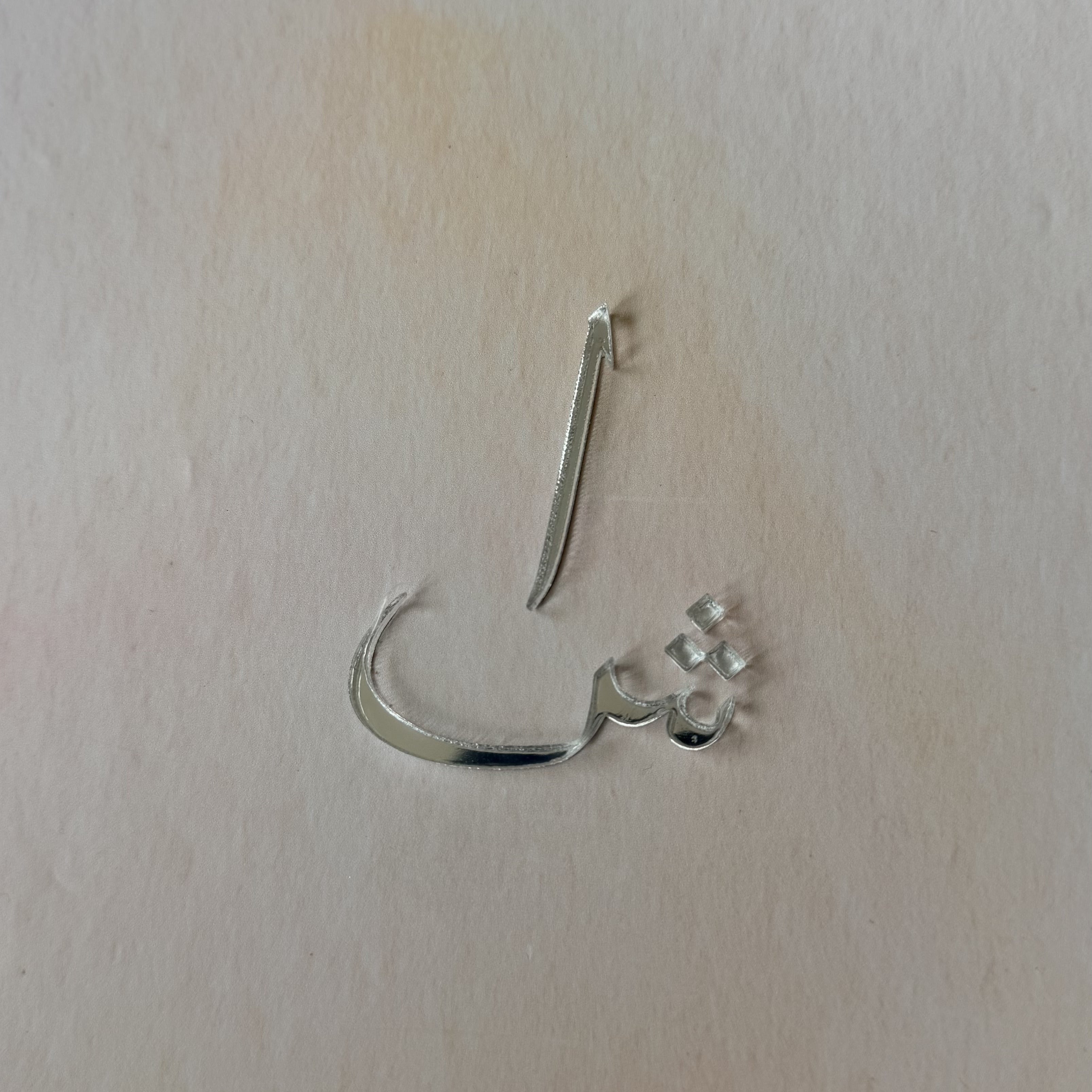 A silver-toned metal nose hoop earring with a small cluster of clear rhinestones on one end, shown on a plain off-white background.