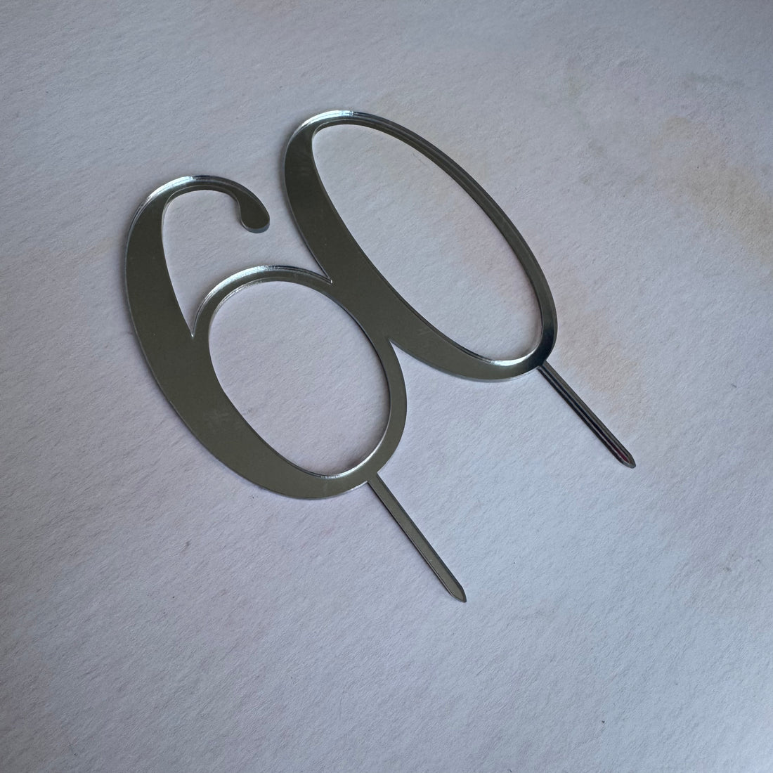 Silver mirror acrylic number 60 topper seen at an angle – personalised mirror acrylic number topper – Etch 'N' Shine