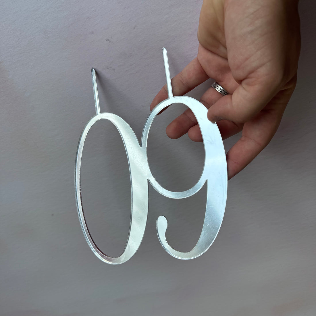 Close-up of silver mirror acrylic number 60 cake topper – personalised mirror number topper – Etch 'N' Shine