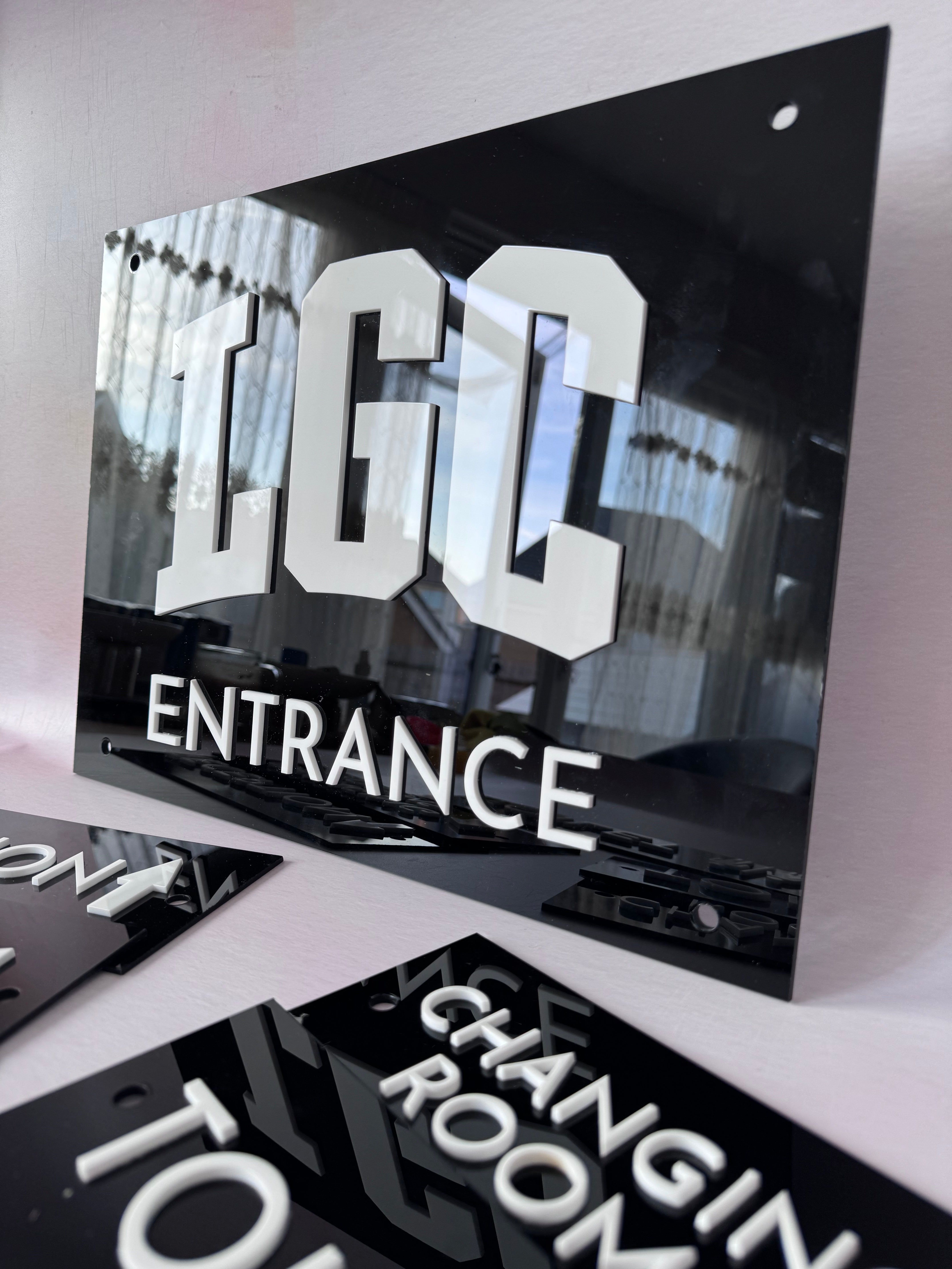Black layered acrylic door sign set with custom LGC business branding