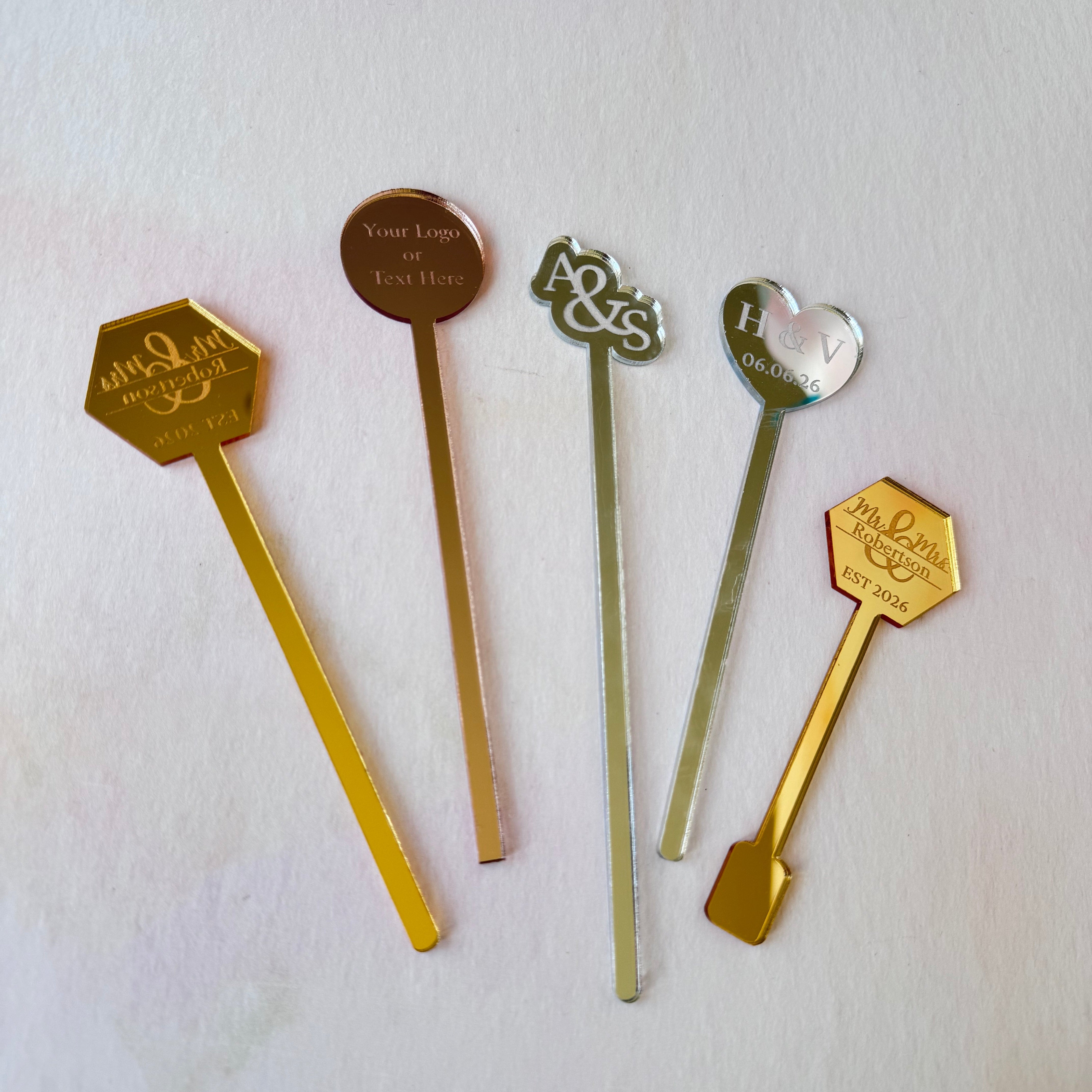 Flat lay of gold, silver and rose gold mirror acrylic wedding drink stirrers – Etch 'N' Shine