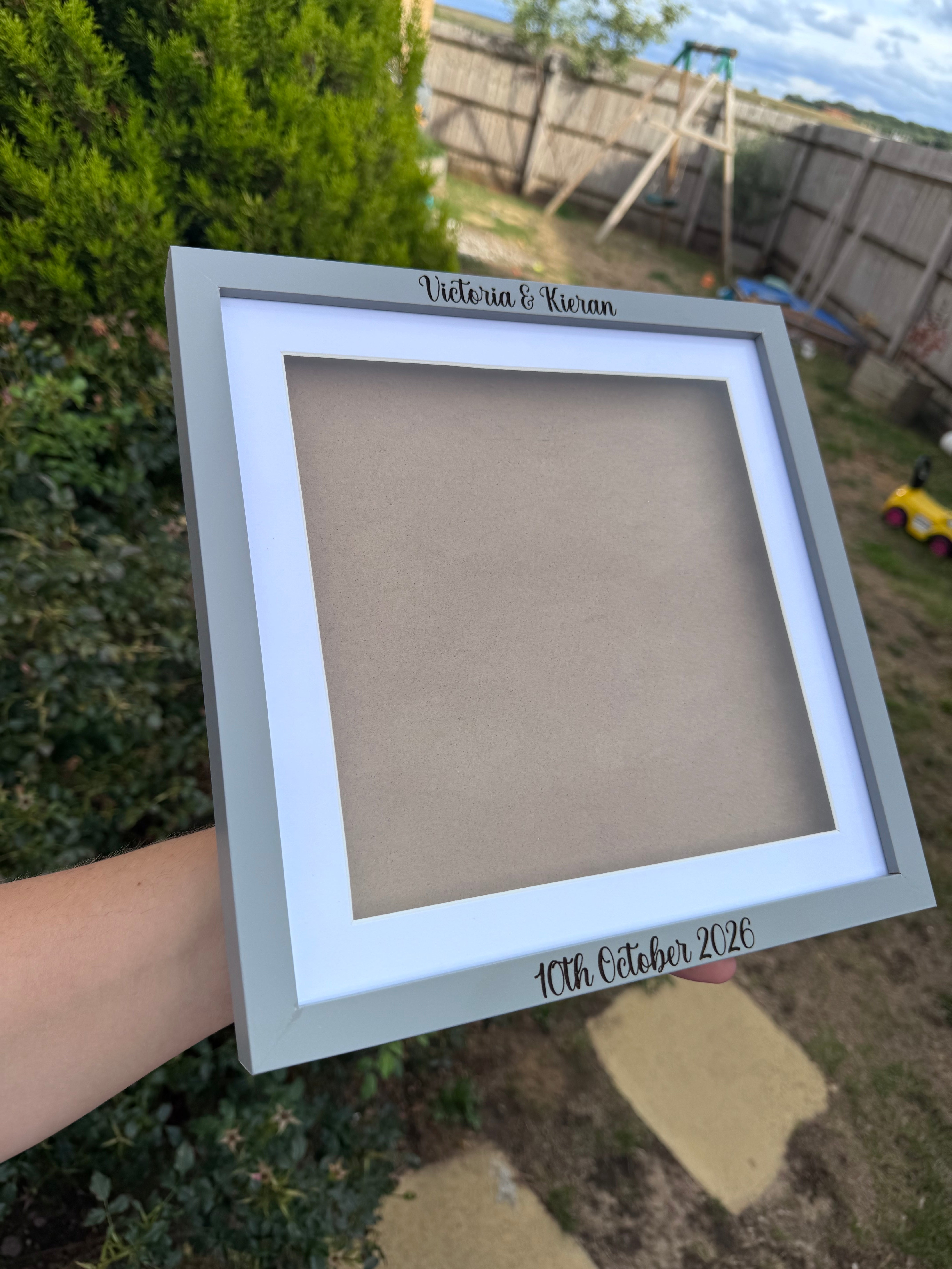 Personalised 18cm shadow box frame shown in use with custom names