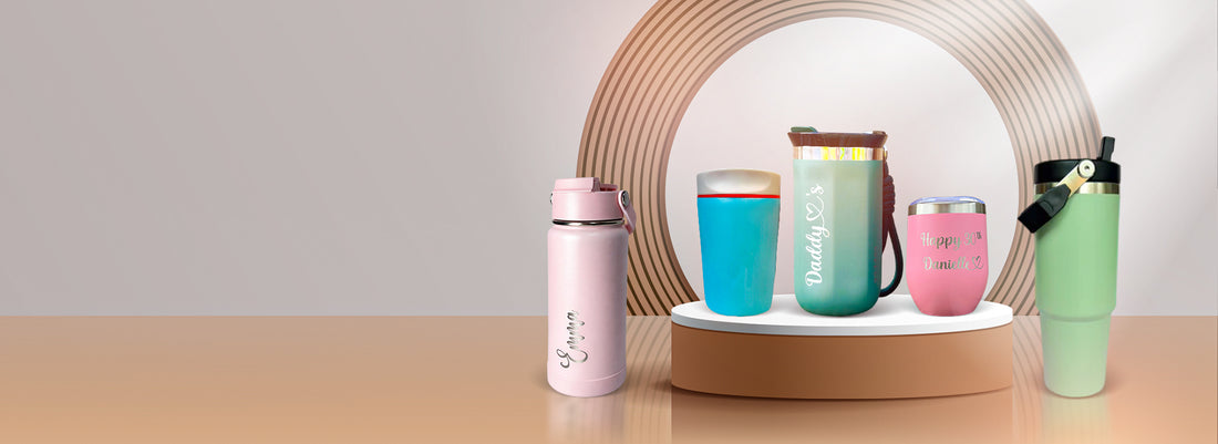 Set of colorful insulated cups on a wooden surface with a neutral background