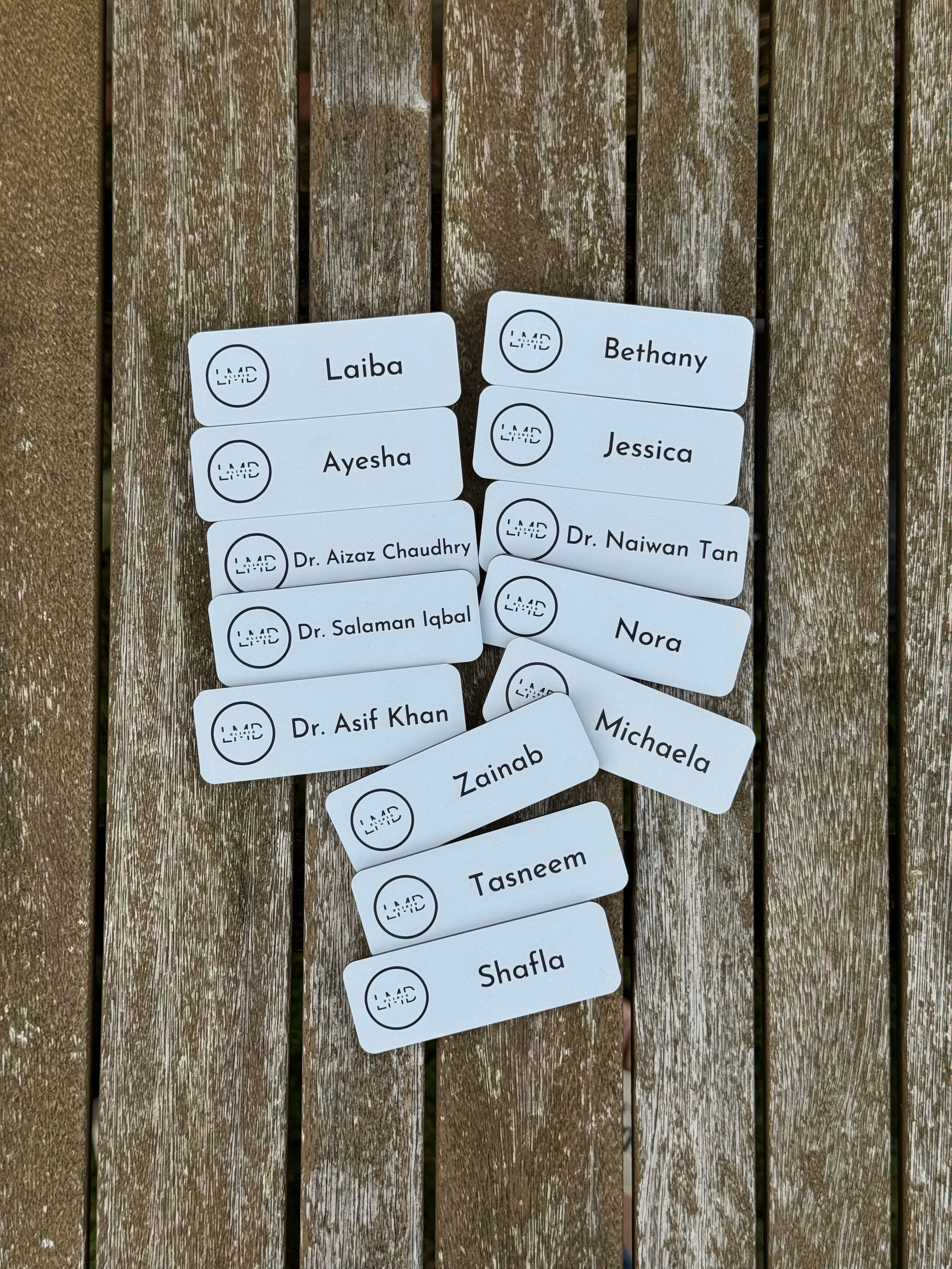 Set of name tags on a wooden surface