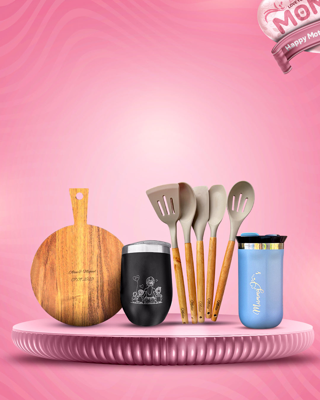 Set of kitchen utensils and tumblers on a pink platform with a 'Happy Mother's Day' banner.