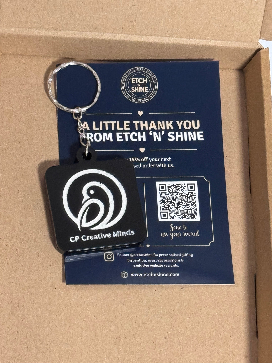 Custom black NFC acrylic keyrings with engraved logo presented in packaging