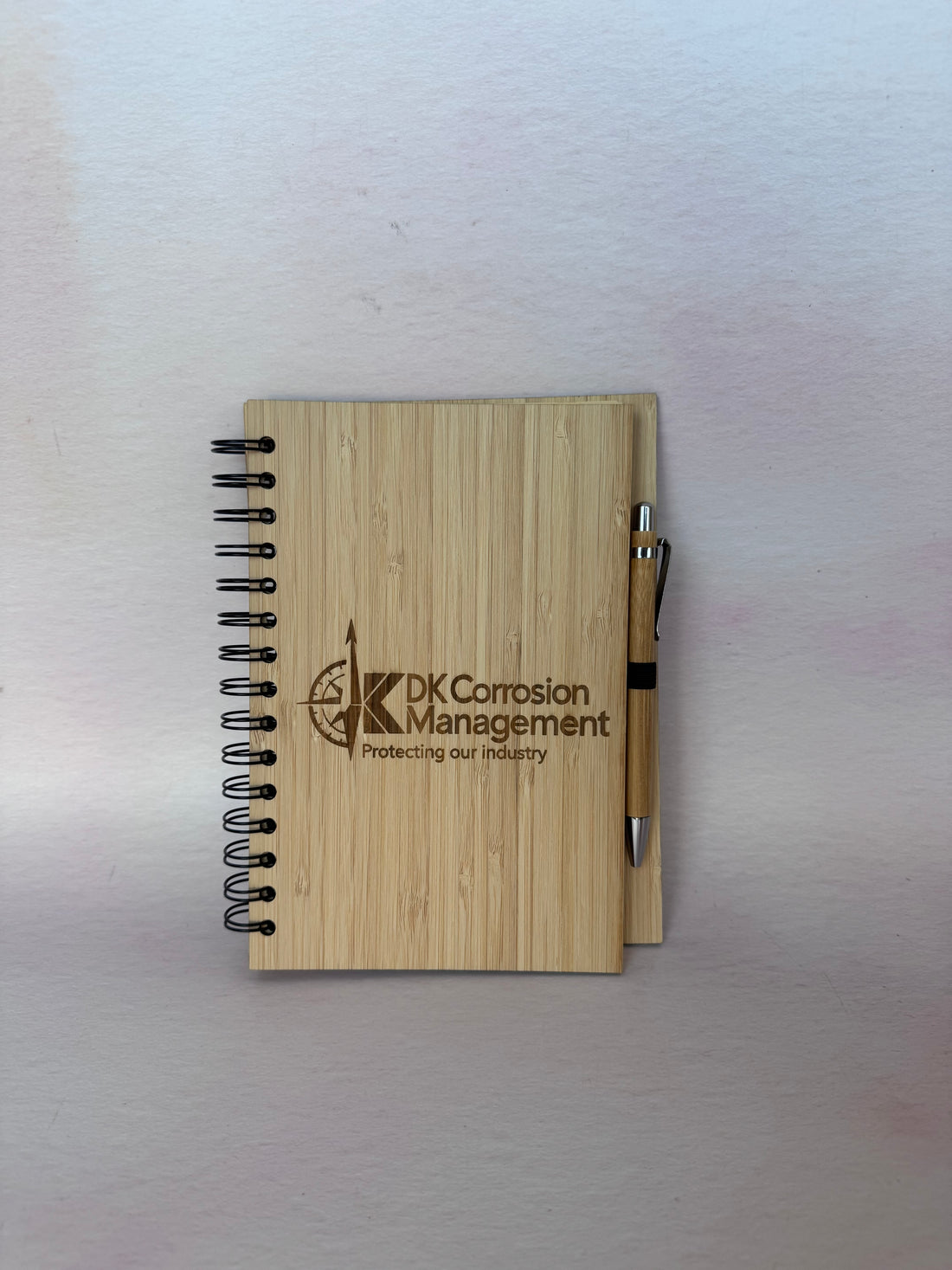 Bamboo spiral notebook with pen engraved with the DK Corrosion Management logo – Etch 'N' Shine