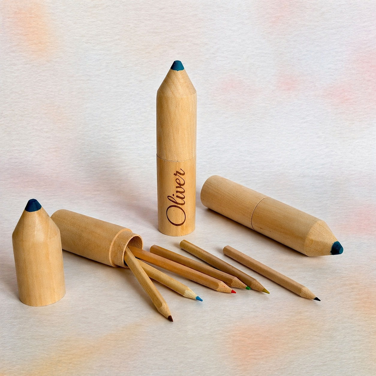 Set of wooden colored pencils with a branded pencil on a light textured background
