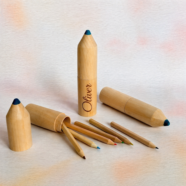 Set of wooden colored pencils with a branded pencil on a light textured background