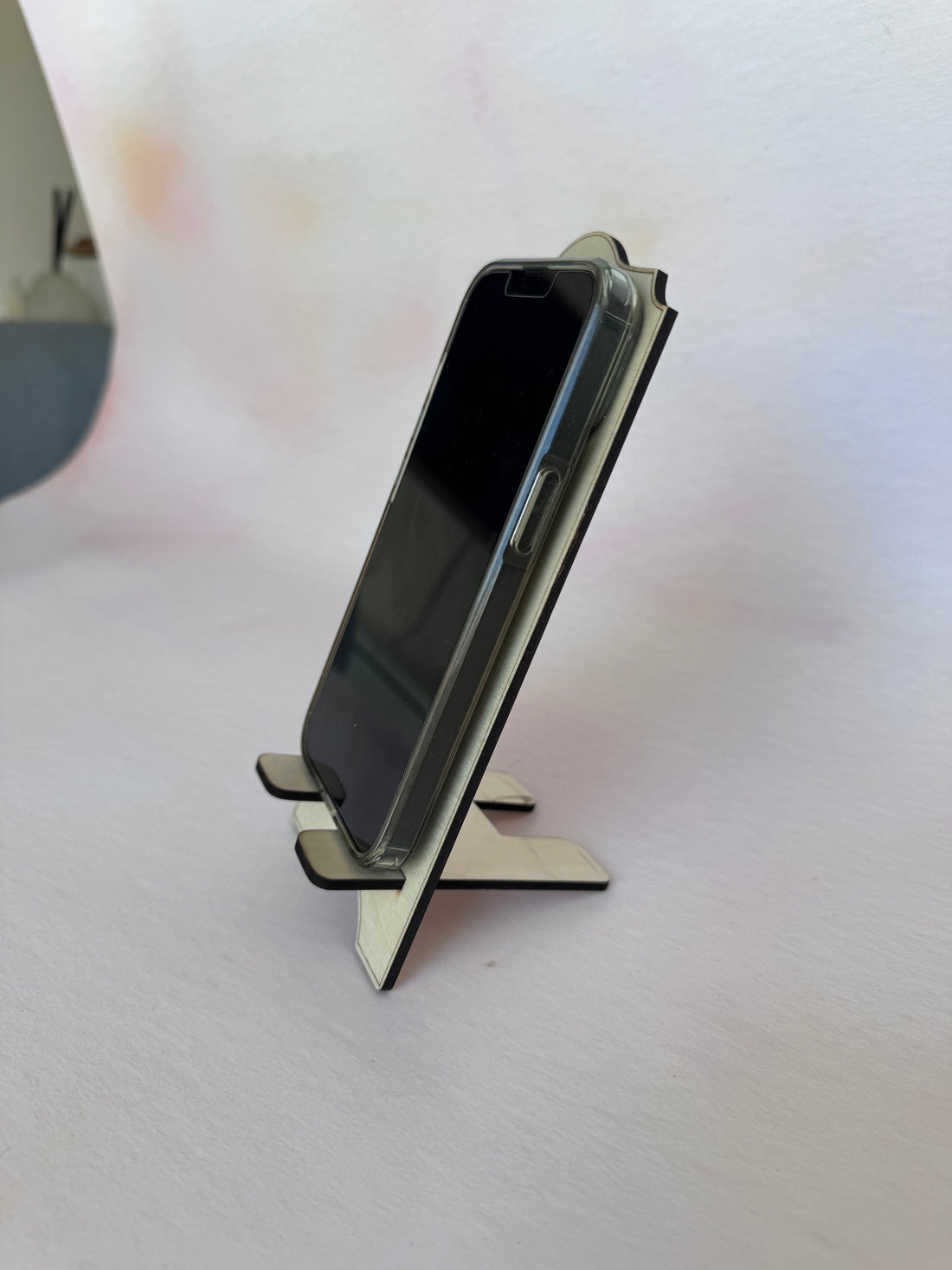 Phone resting in a personalised wooden phone stand, second view – Etch 'N' Shine