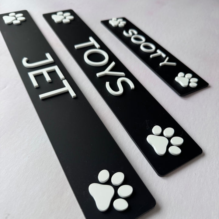 Close-up of raised white lettering on black layered acrylic pet name plaques