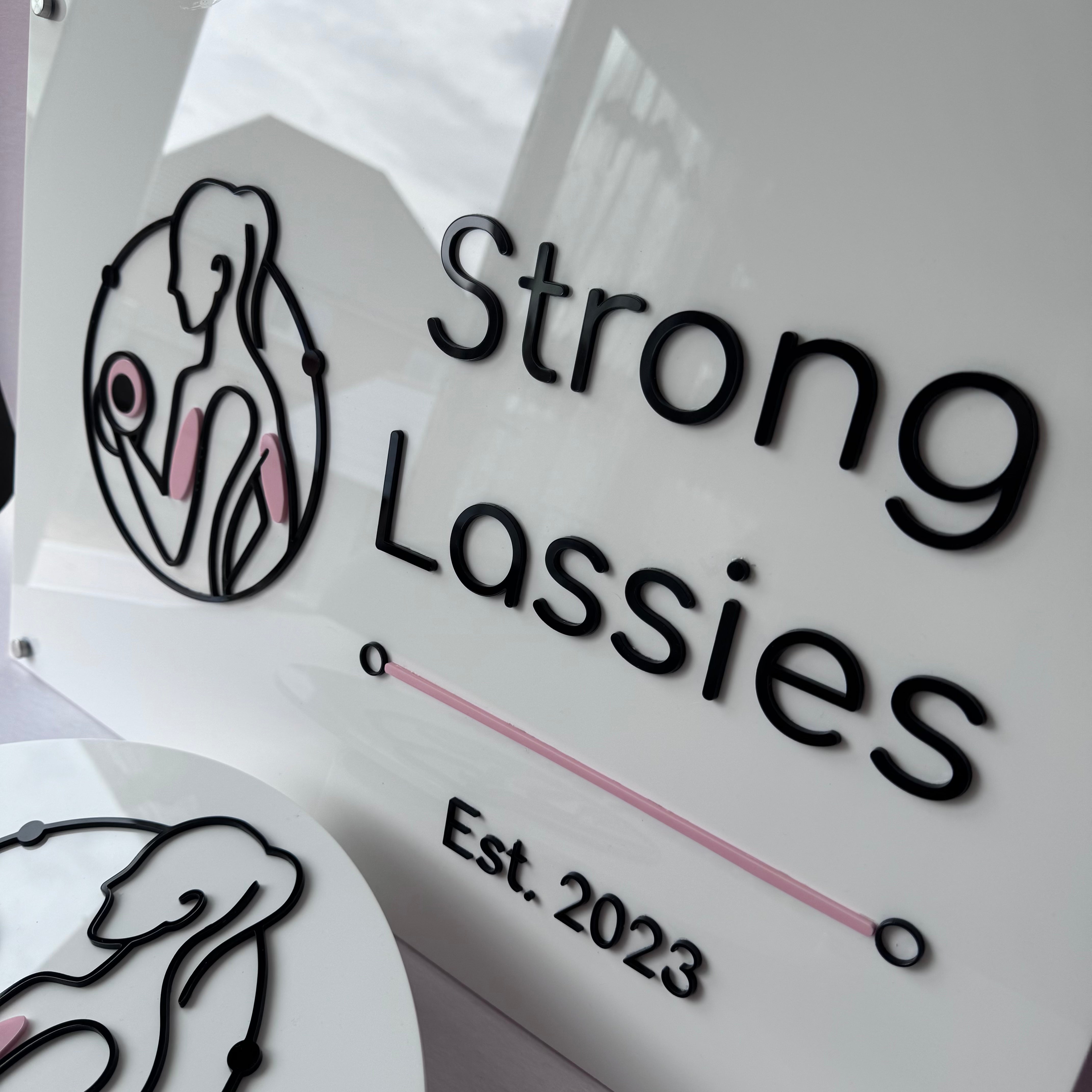 Close-up of precision-cut layered acrylic business signage