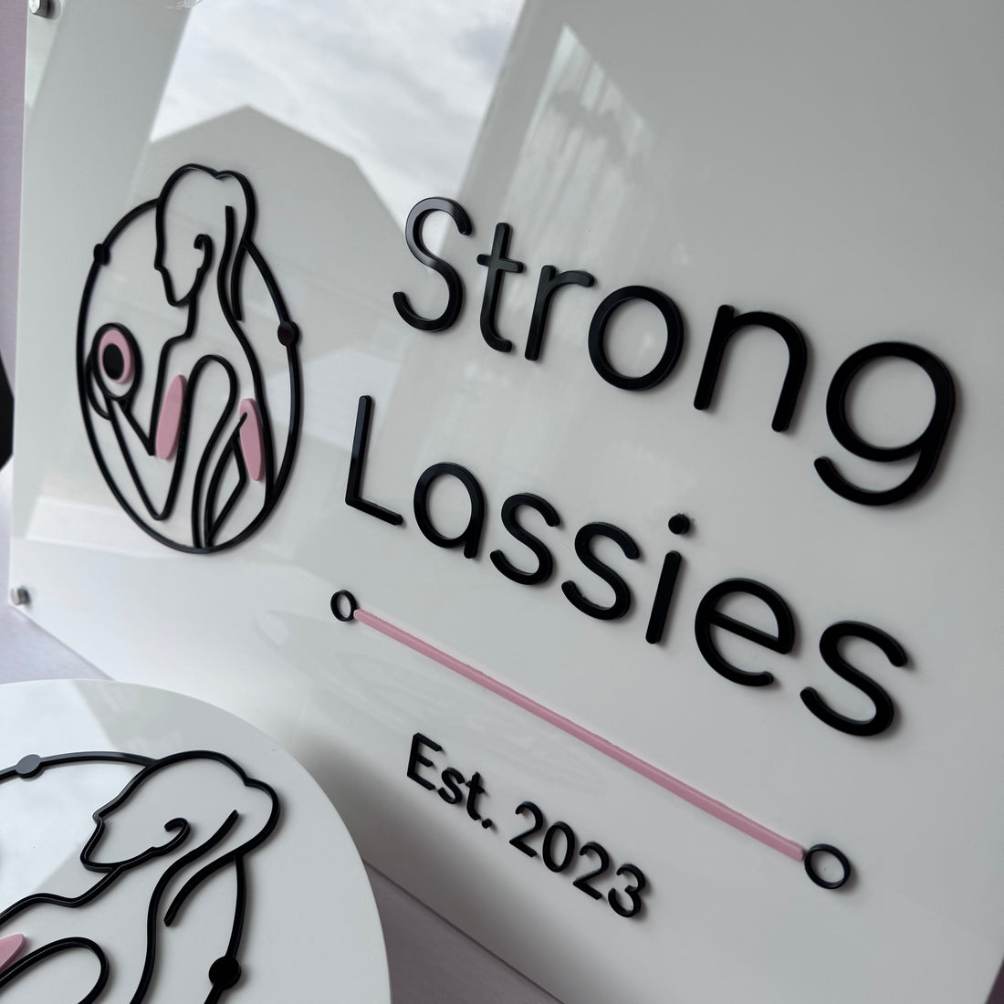 Close-up of precision-cut layered acrylic business signage