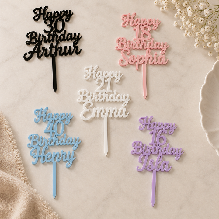 Personalized birthday cake toppers with names and ages on a neutral background.