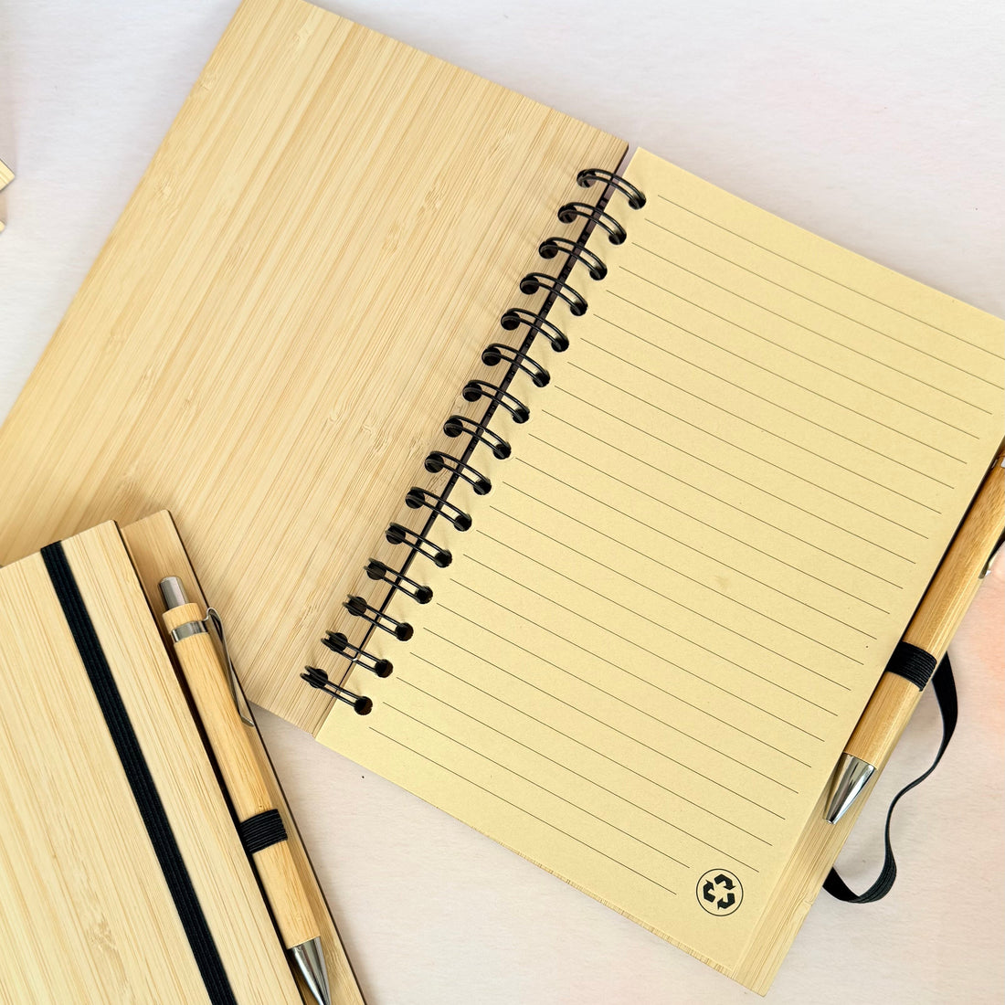 Notebook with pen and pencil on a light background