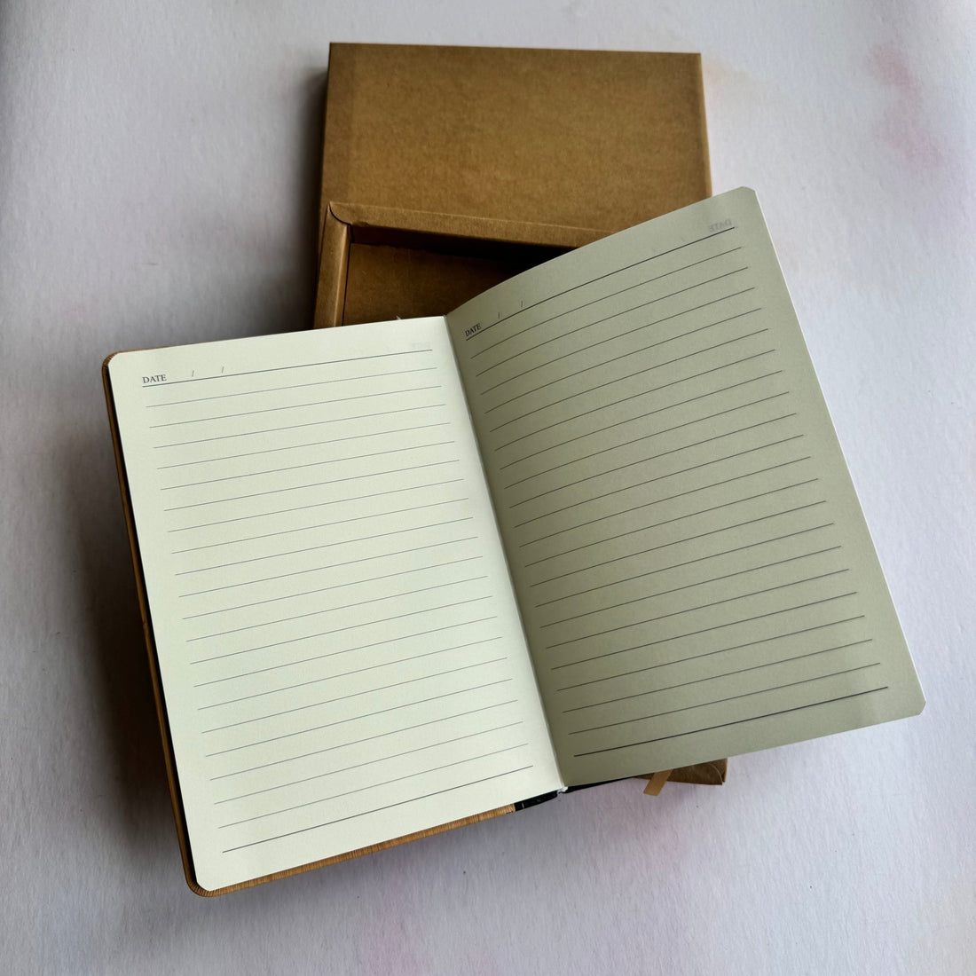 Open bamboo notebook showing lined pages beside kraft gift box – personalised bamboo notebook and pen set – Etch 'N' Shine