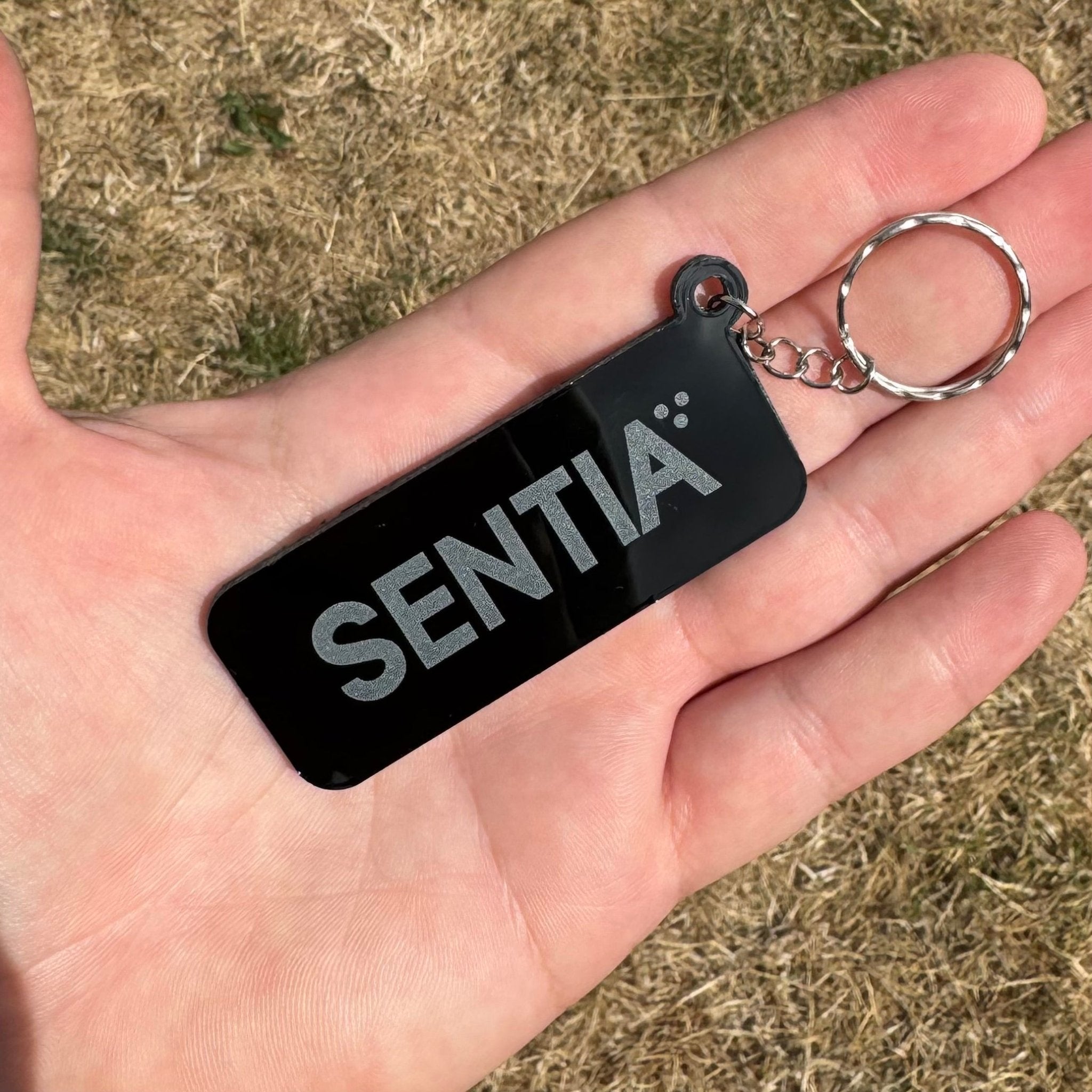 Black acrylic keyring with custom text held in hand – engraved NFC keyring – Etch 'N' Shine
