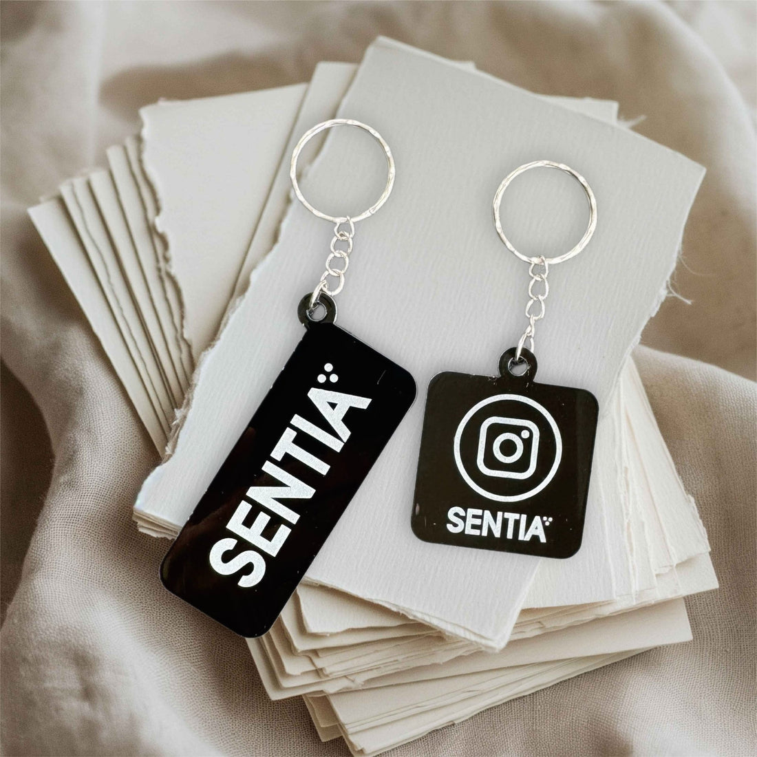 Two black acrylic keyrings with custom logo and text – personalised engraved acrylic keyring – Etch 'N' Shine
