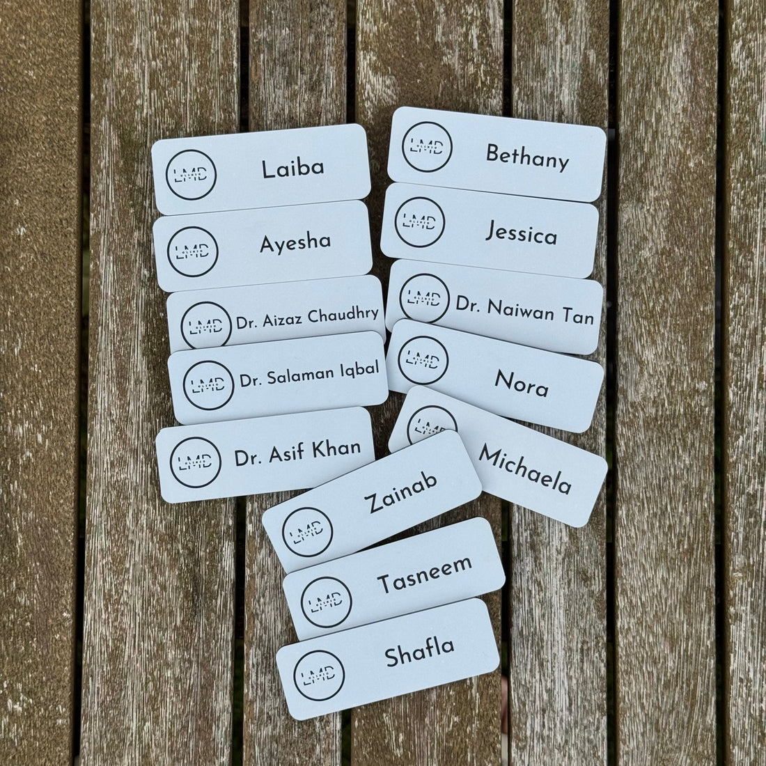 Multiple white acrylic name badges with custom names and logo – engraved name badges – Etch 'N' Shine