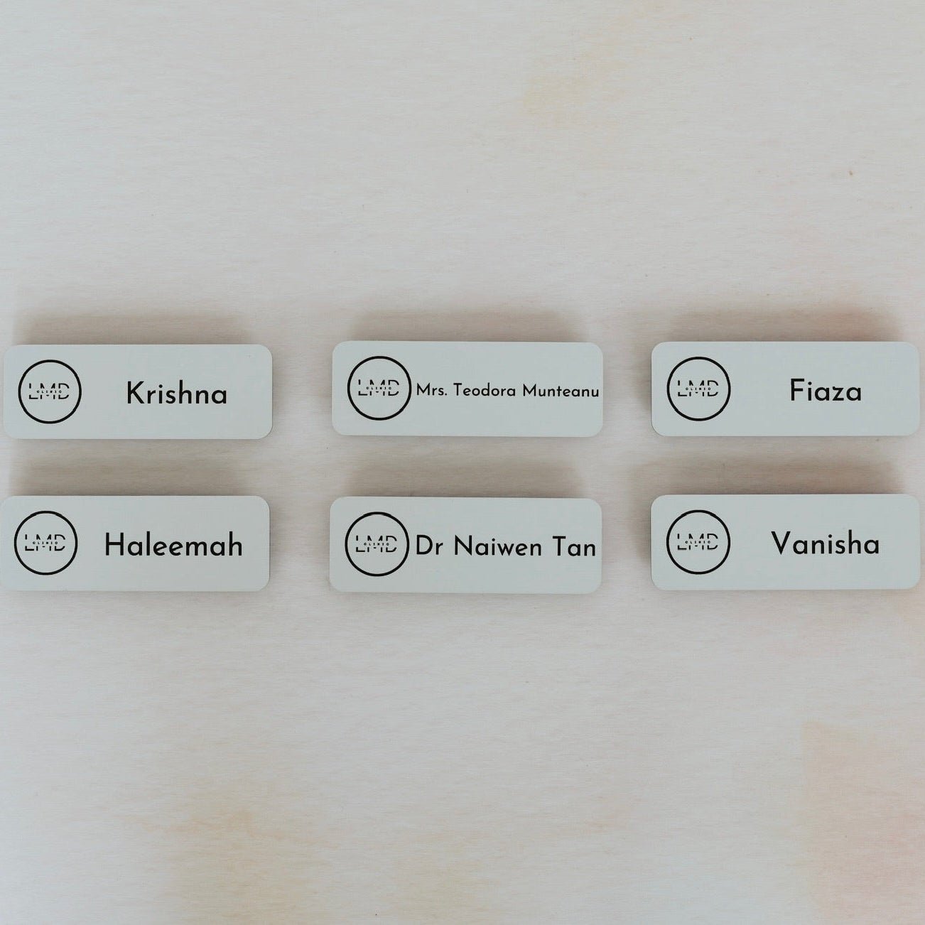 Six white acrylic name badges with custom names and logo – engraved magnetic name badges – Etch 'N' Shine