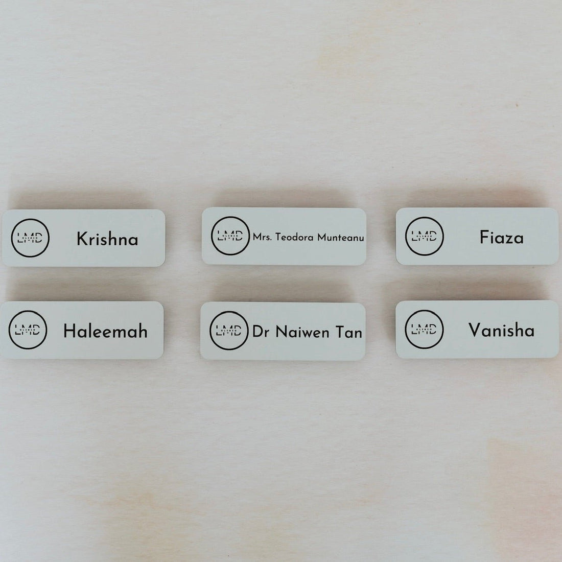 Six white acrylic name badges with custom names and logo – engraved magnetic name badges – Etch 'N' Shine