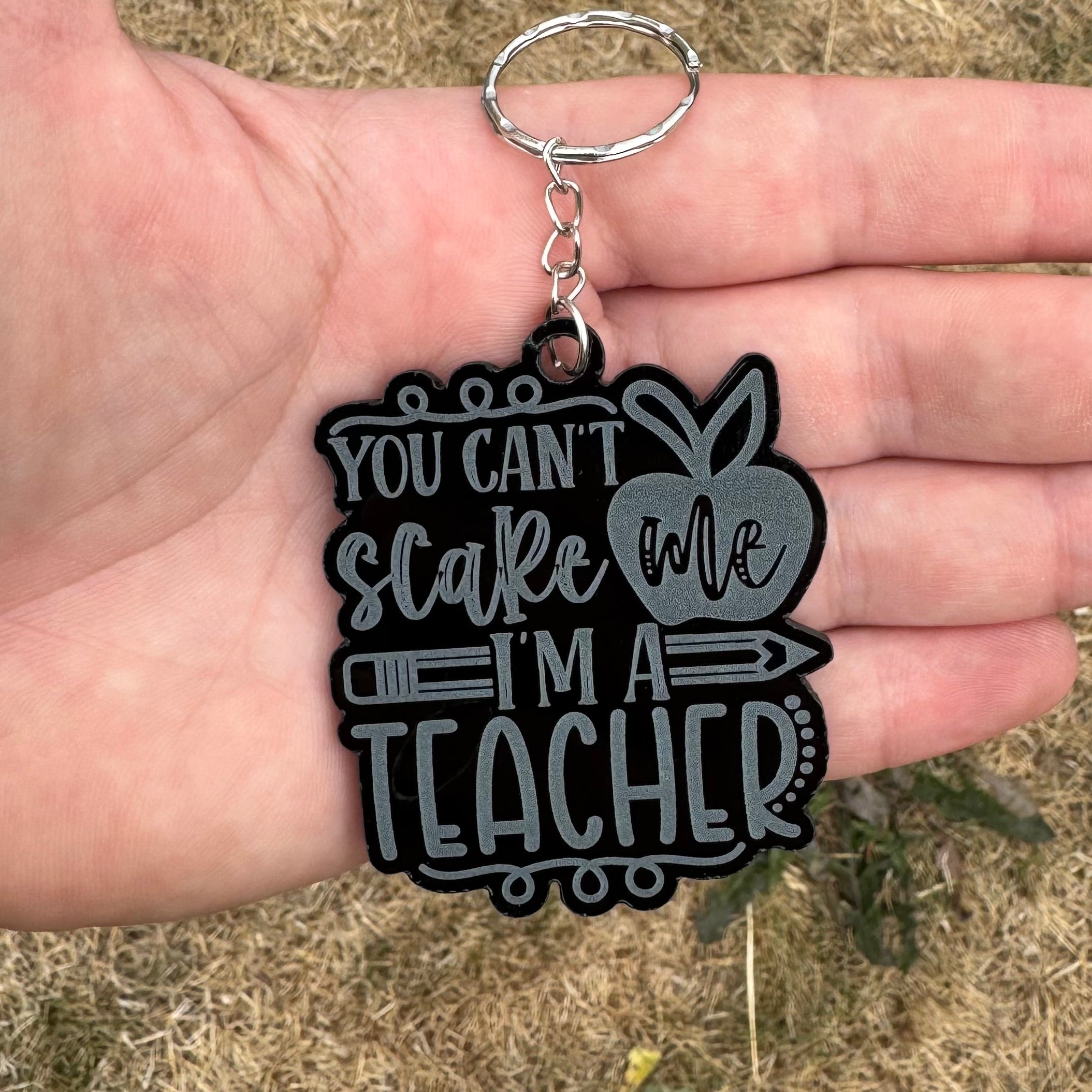 Funny teacher gift keychain with message ‘You can’t scare me, I’m a teacher’ in silver text on black gloss acrylic – personalised end-of-year gift
