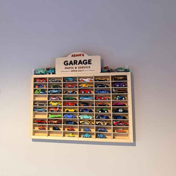 Cartoon tow truck wall decoration next to a wooden toy car display.