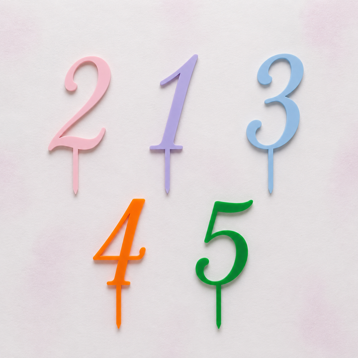 Colorful number cake toppers on a light pink background - Etch 'N' Shine