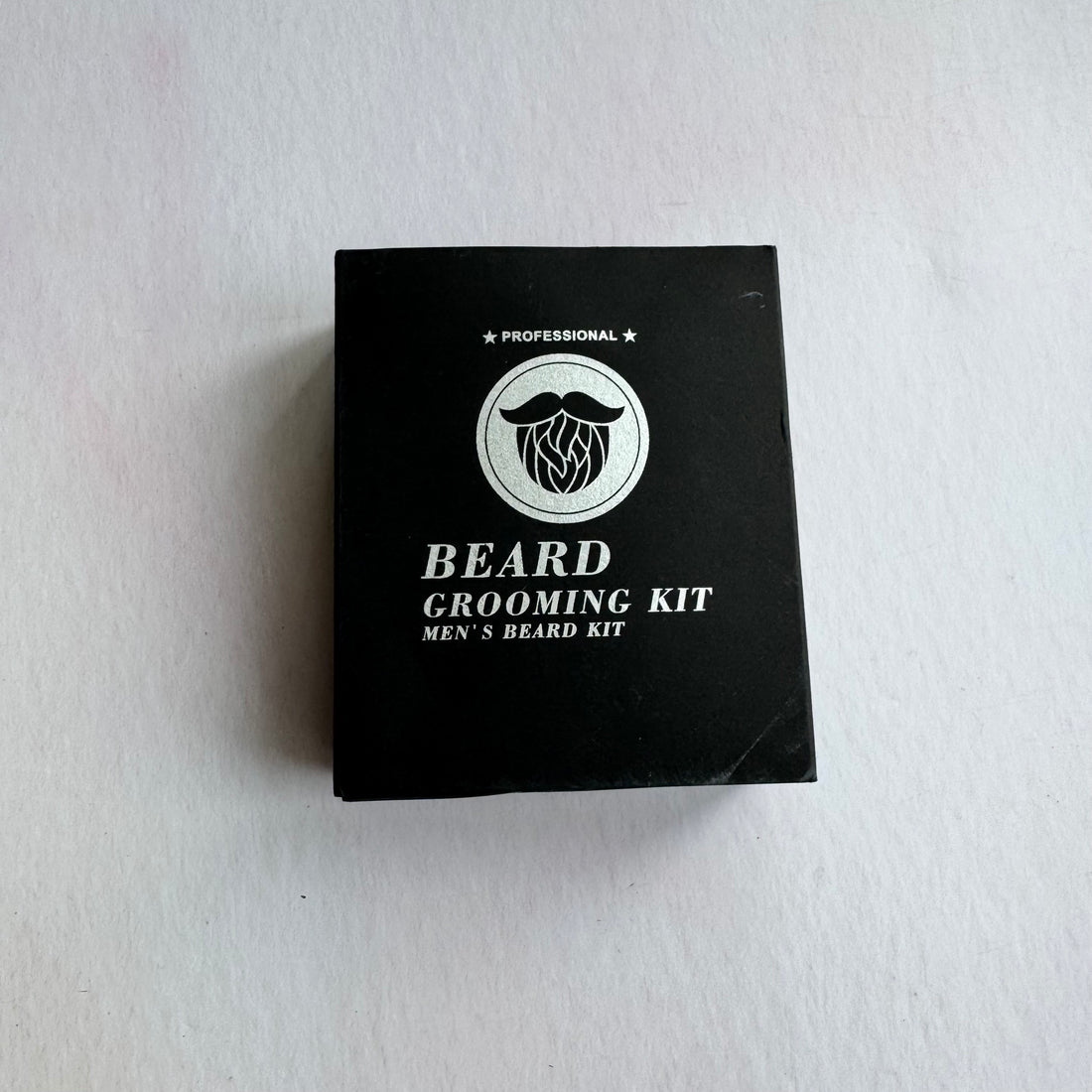 Black box of a beard grooming kit on a white background