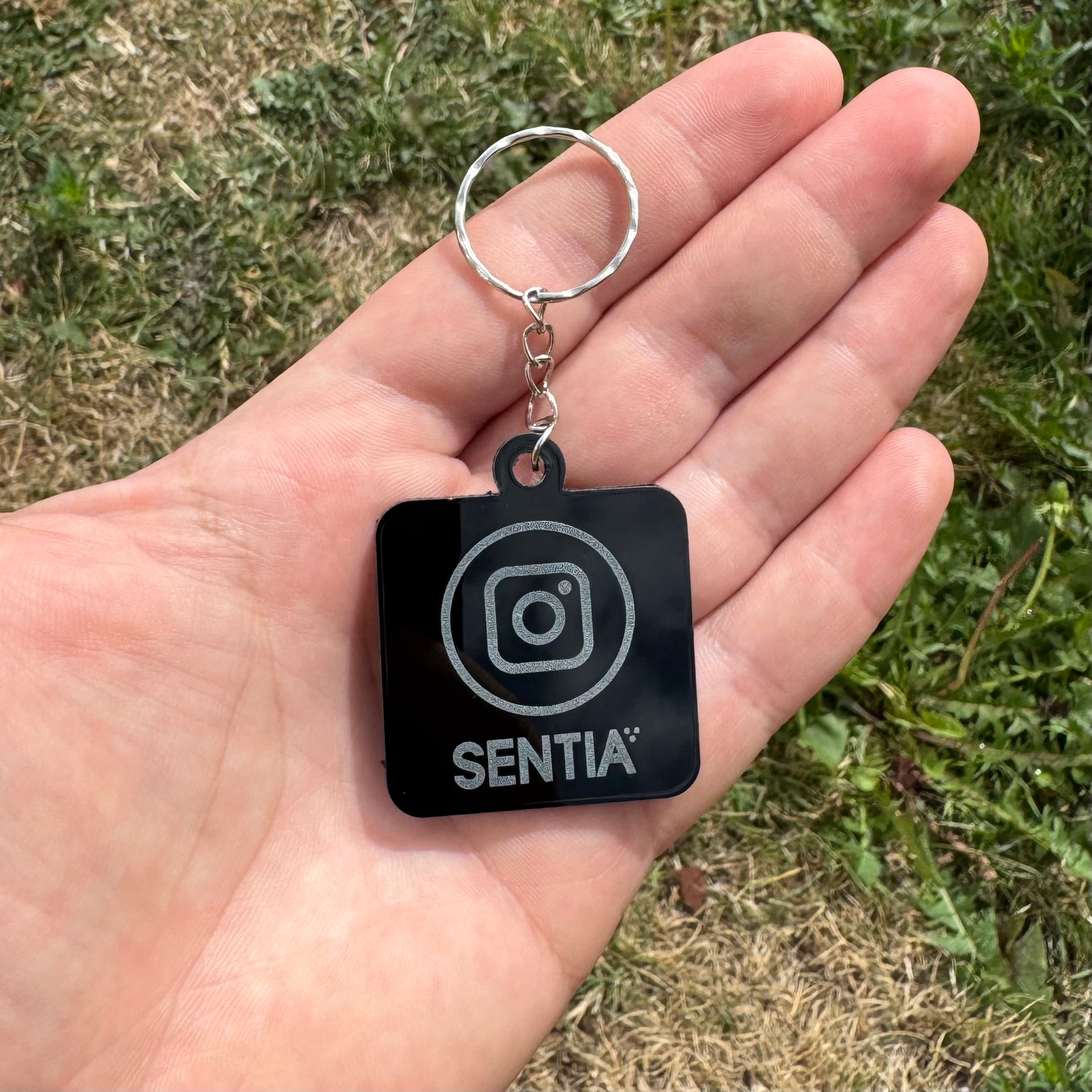 Glossy black acrylic NFC keychain with Instagram icon and SENTIA logo – personalised tap-to-link keyring for social media sharing