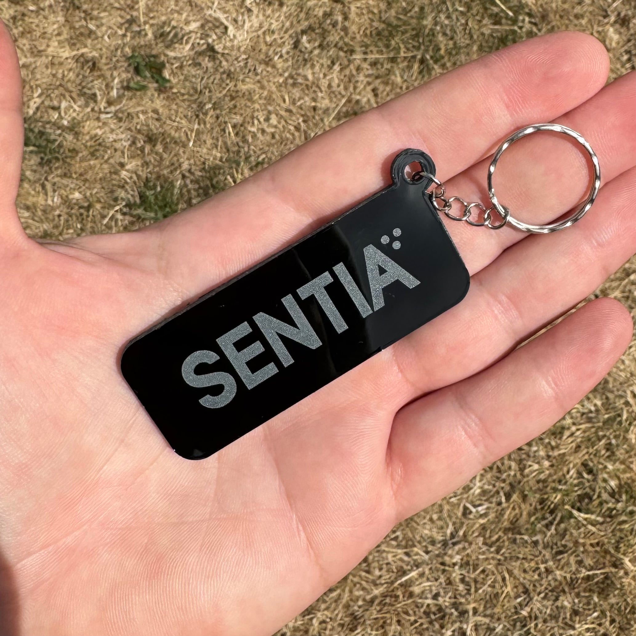 Custom black NFC keychain in rectangle shape with SENTIA logo – stylish smart keyring for linking websites or digital profiles