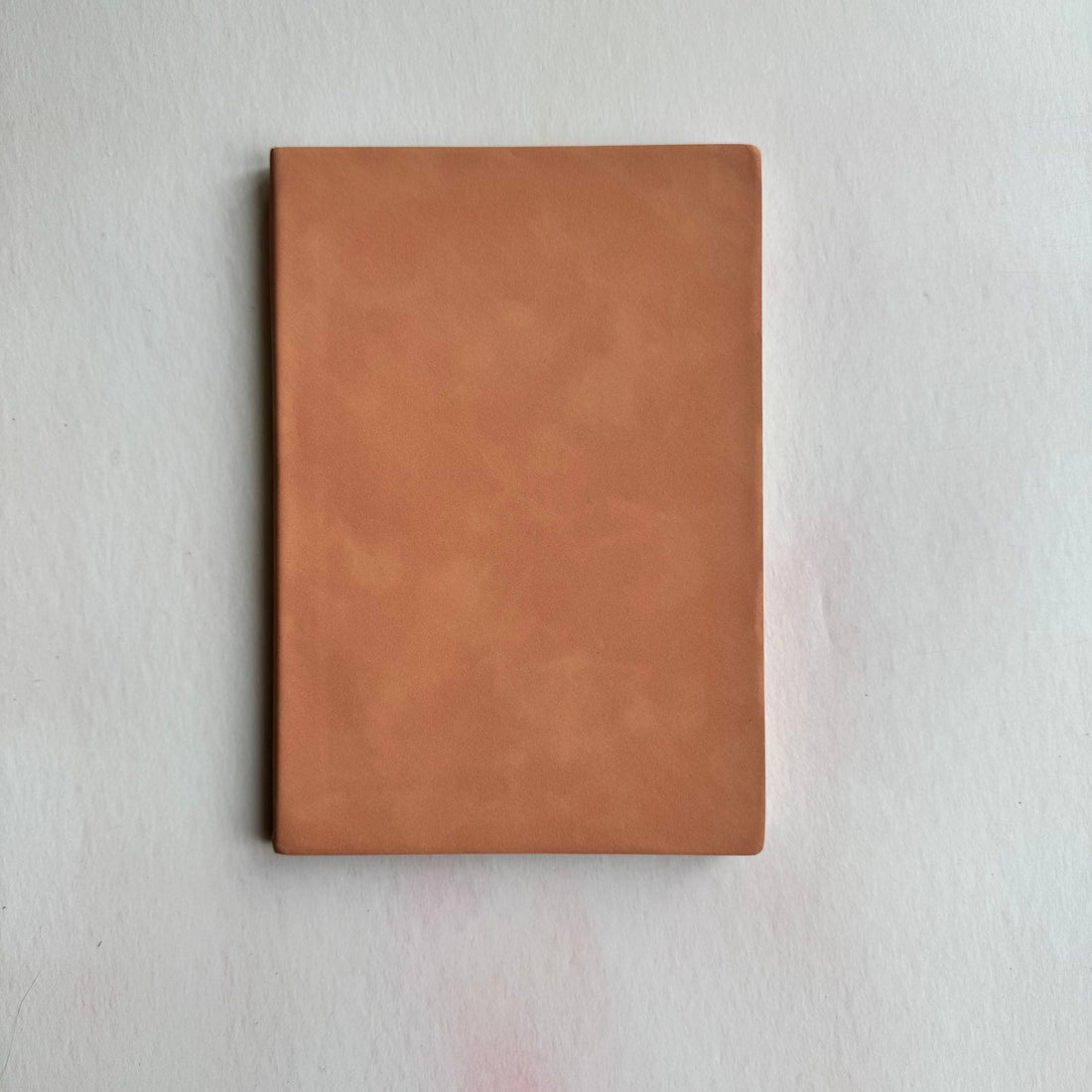 Plain tan faux leather cover of an A5 notebook on a white surface – personalised faux leather notebook – Etch 'N' Shine
