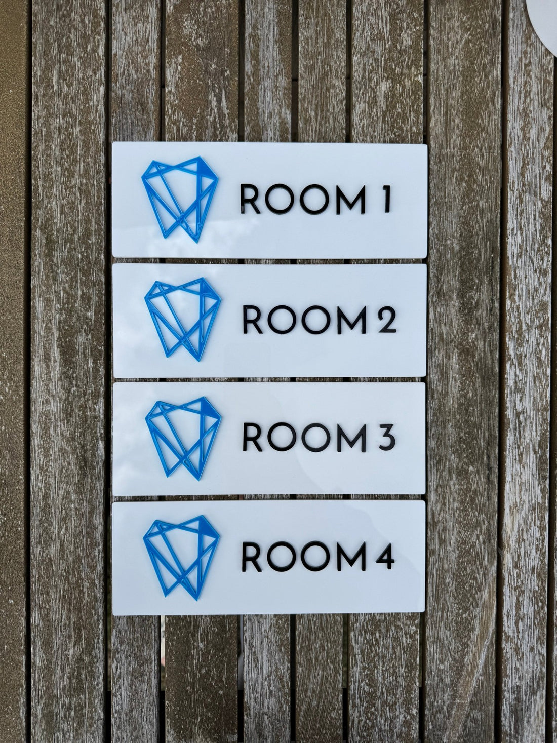 Four white acrylic signs with custom logo and room numbers – engraved acrylic door signs – Etch 'N' Shine