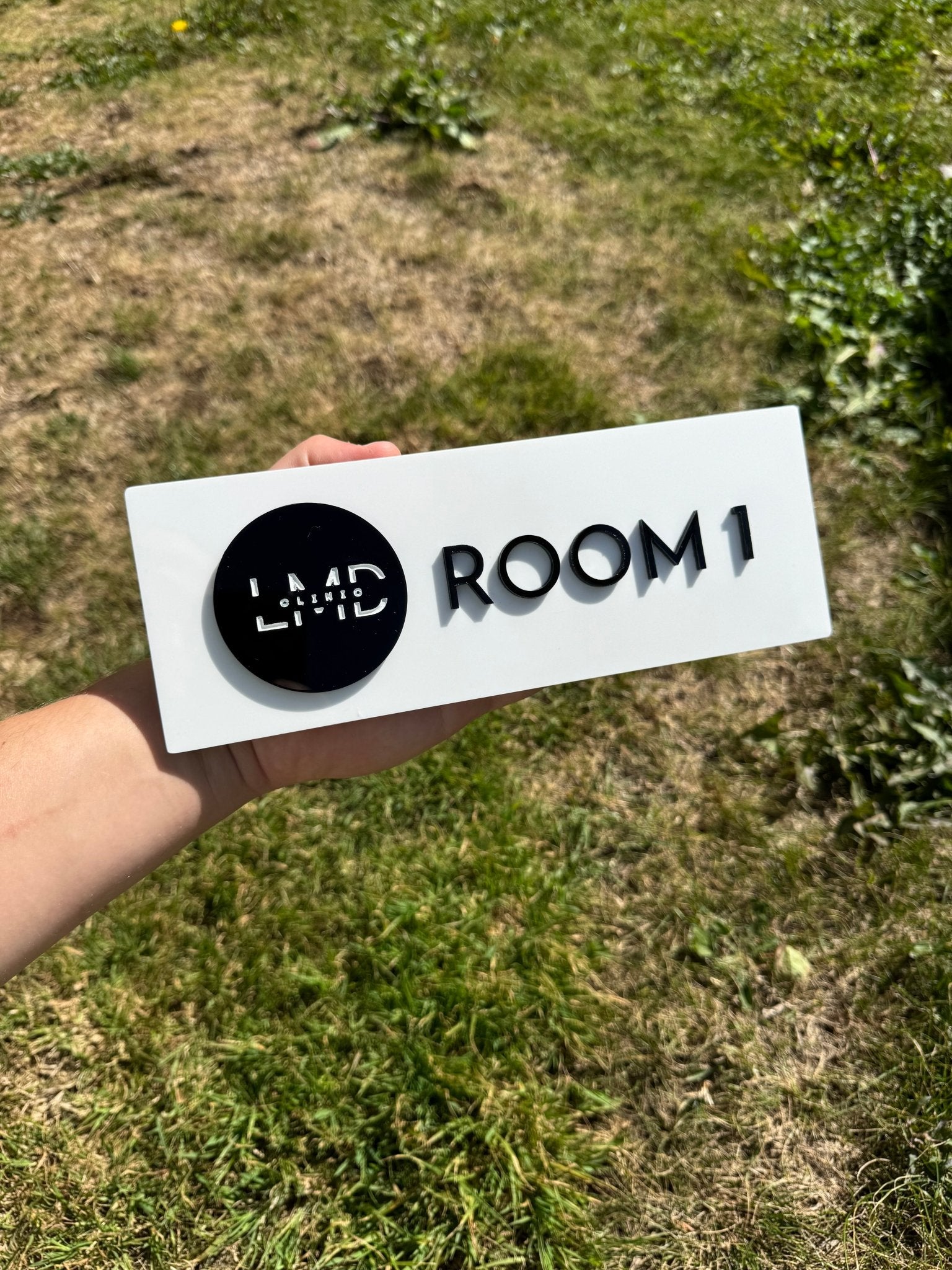 White acrylic door sign with black circular logo disc and custom text – personalised acrylic room sign – Etch 'N' Shine