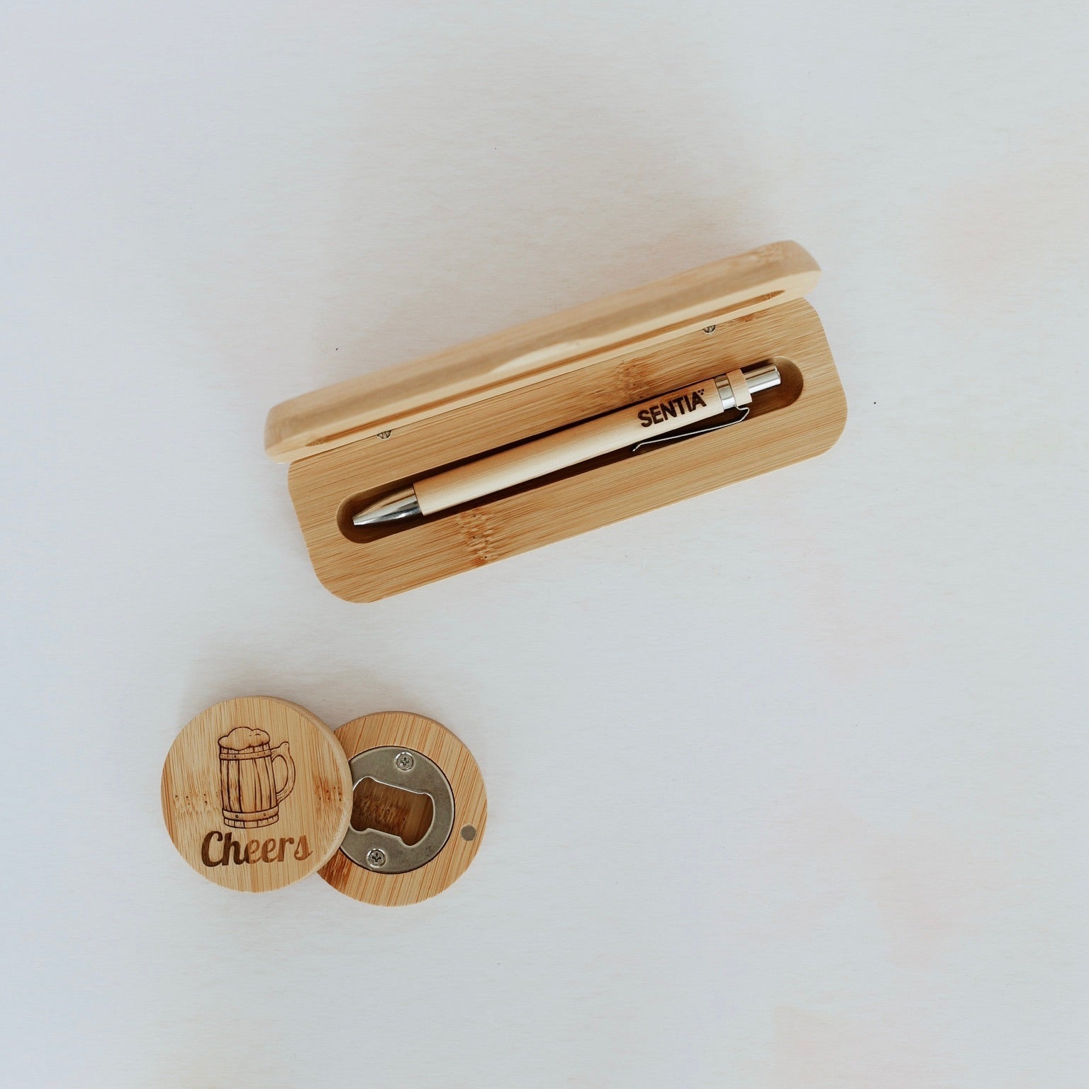 Engraved bamboo pen in open bamboo case alongside engraved round bottle opener – personalised bamboo pen set – Etch 'N' Shine