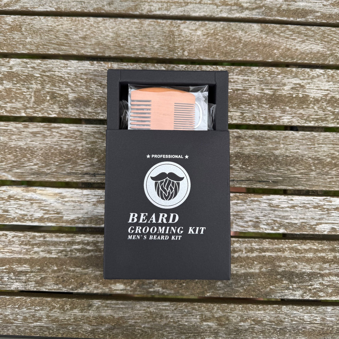 Beard grooming kit open in black gift box with wooden comb on wooden surface – personalised bamboo beard kit – Etch 'N' Shine
