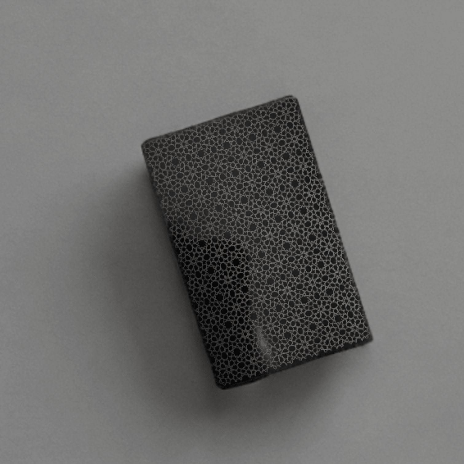 Black anodised aluminium business card with laser-engraved geometric pattern – custom metal business card – Etch 'N' Shine