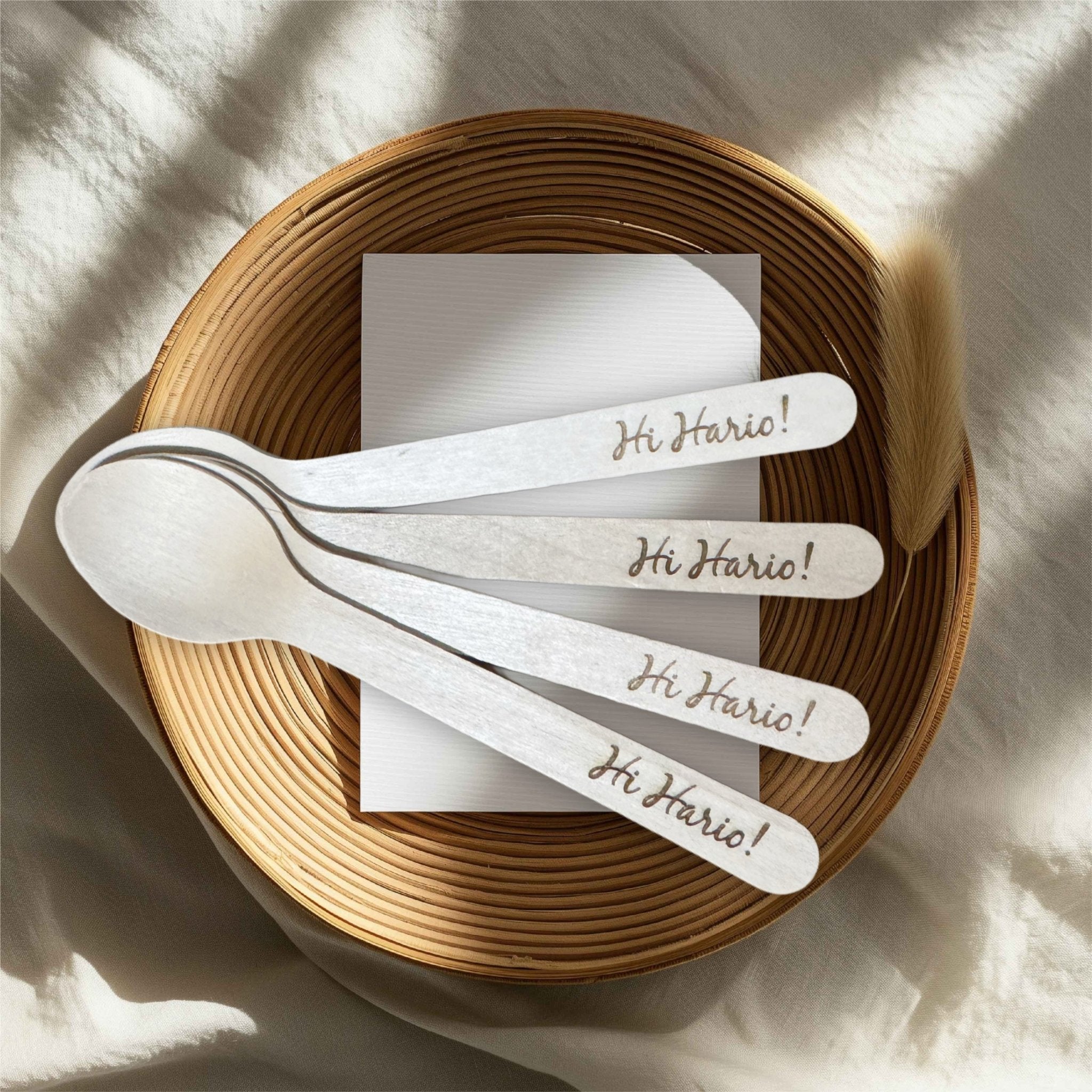 Four engraved wooden spoons with custom text arranged in a wicker basket – personalised wooden spoons – Etch 'N' Shine