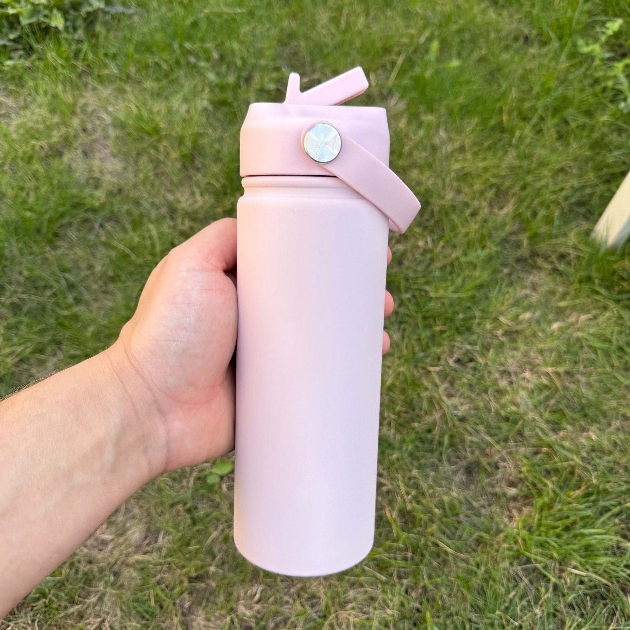 Pink insulated bottle with flip lid held outdoors – personalised steel water bottle – Etch 'N' Shine